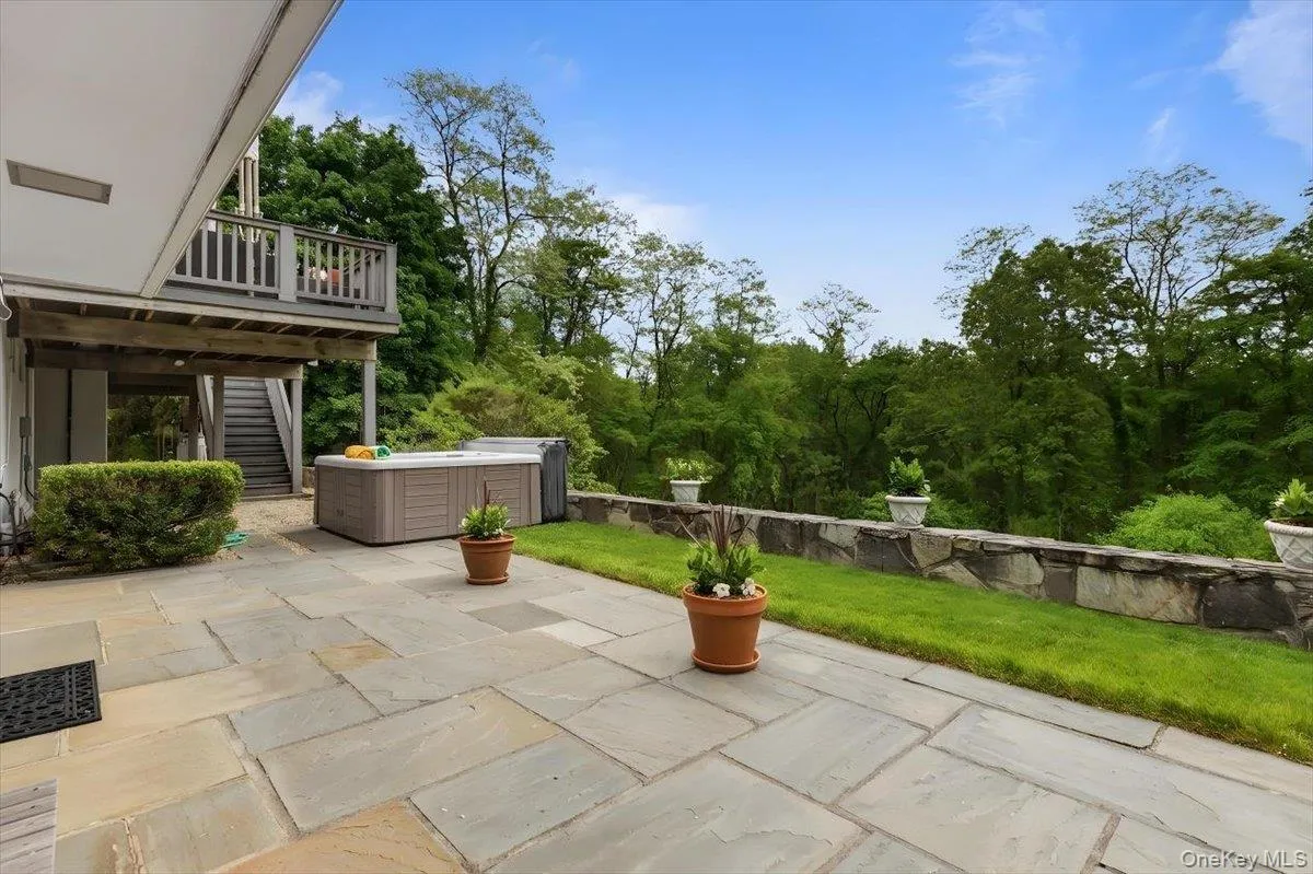 The rear flagstone patio just steps outside the lower level, and also steps off the Trex Deck on the main floor. The rear flagstone patio just steps outside the lower level, and also steps off the Trex Deck on the main floor.