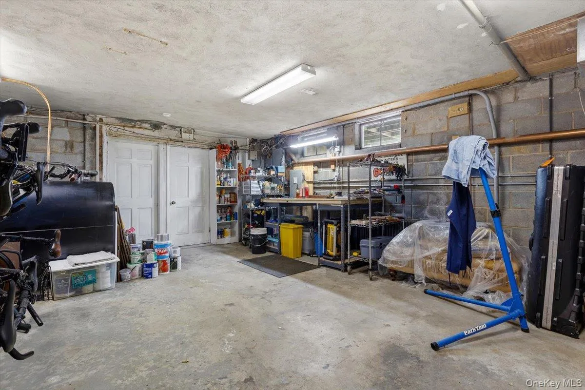 An added bonus is the very large unfinished basement with a workshop area, and, not pictured, a room with a large new stainless steel utility sink. One door lead straight to your attached two-car garage, the other to the wine cellar under the stairway. An added bonus is the very large unfinished basement with a workshop area, and, not pictured, a room with a large new stainless steel utility sink. One door lead straight to your attached two-car garage, the other to the wine cellar under the stairway.