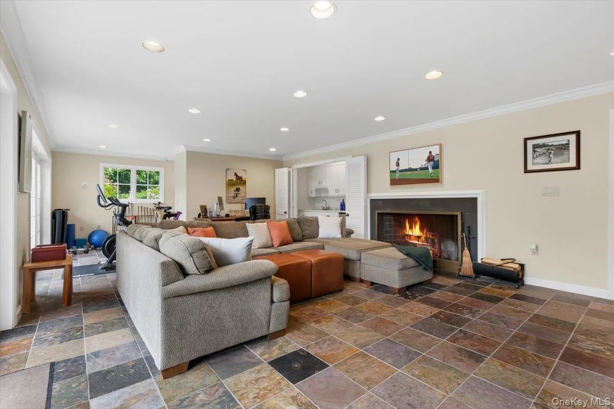 The Recreation Room also offers a 2nd wood-burning fireplace with marble surround. In the distance you'll see an area dedicated to exercise equipment. The Recreation Room also offers a 2nd wood-burning fireplace with marble surround. In the distance you'll see an area dedicated to exercise equipment.