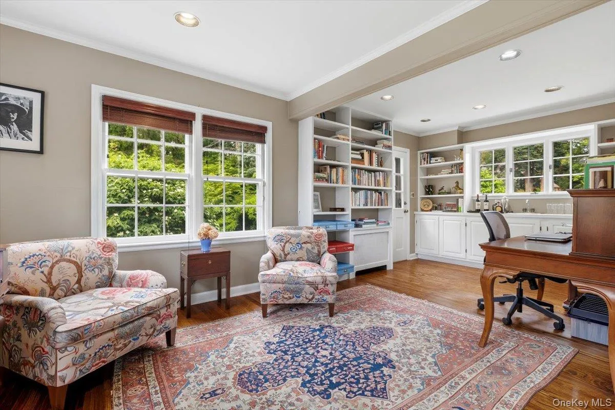 Off one side of the Living Room is this combined Den/Office with a sitting area and separate office area with built-in bookshelves and cabinetry. Off one side of the Living Room is this combined Den/Office with a sitting area and separate office area with built-in bookshelves and cabinetry.