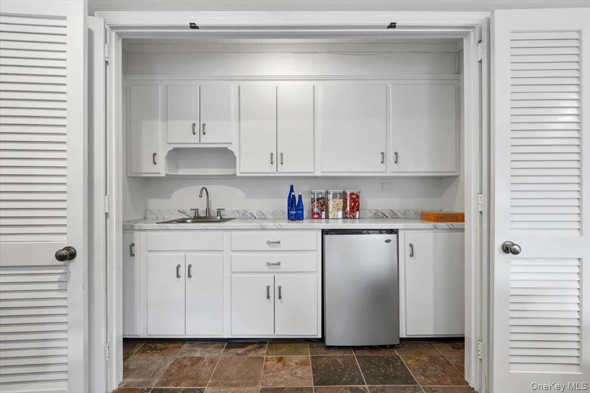 Behind these bifold doors in the Rec Room, you'll find a newly updated summer/entertaining kitchen with new sink and counter. Perfect compliment to the lower level patio. Behind these bifold doors in the Rec Room, you'll find a newly updated summer/entertaining kitchen with new sink and counter. Perfect compliment to the lower level patio.