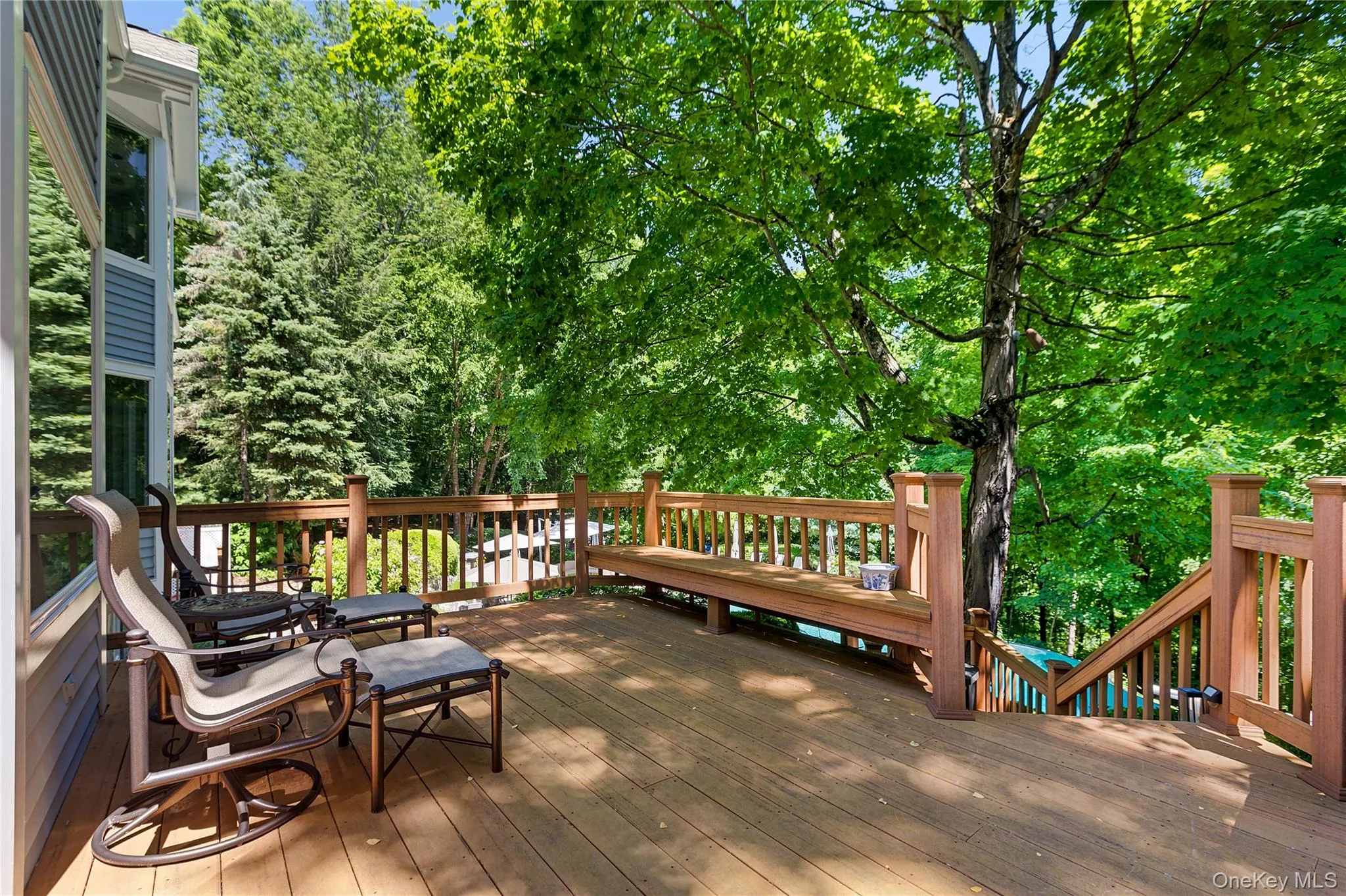 Area of deck with stairs down to hot tub, pool and patio. Area of deck with stairs down to hot tub, pool and patio.