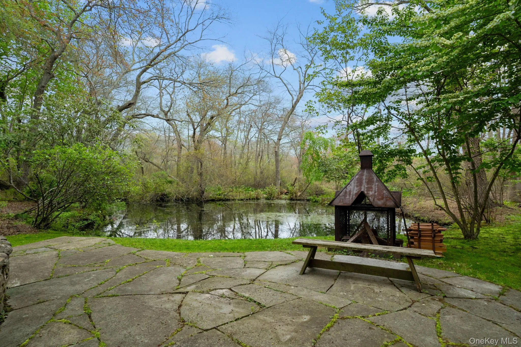Custom Fire pit stone patio overlooking the pond Custom Fire pit stone patio overlooking the pond