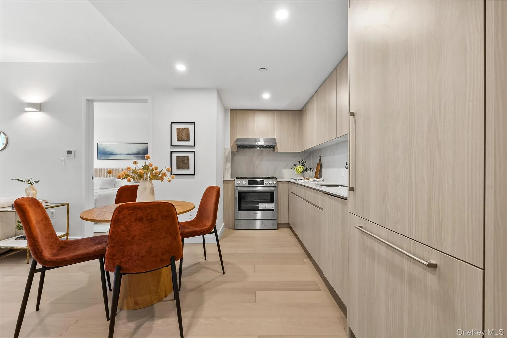 Dining area with light wood-style flooring and recessed lighting Dining area with light wood-style flooring and recessed lighting
