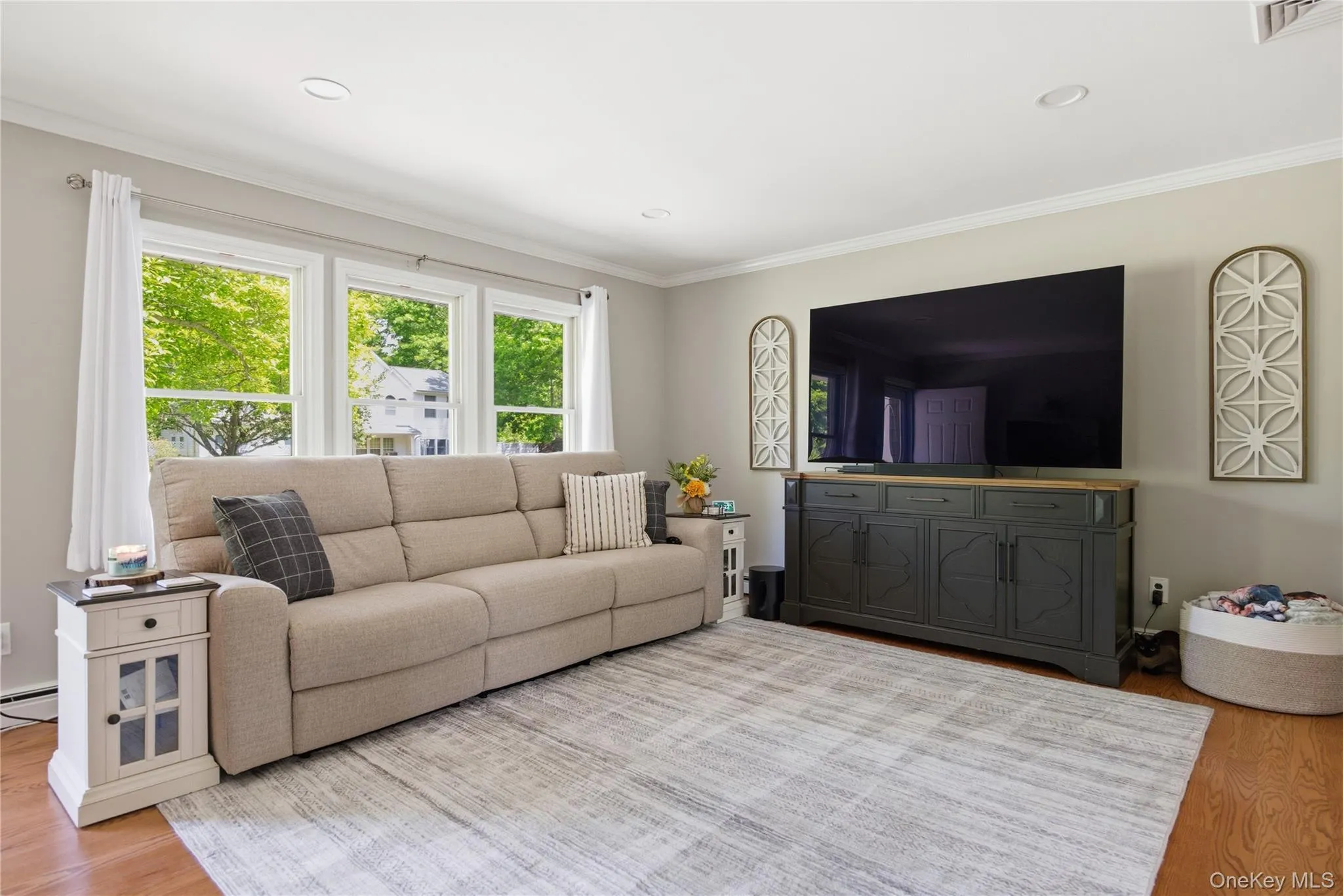 Hardwood flooring complementing light-toned walls and crown molding Hardwood flooring complementing light-toned walls and crown molding