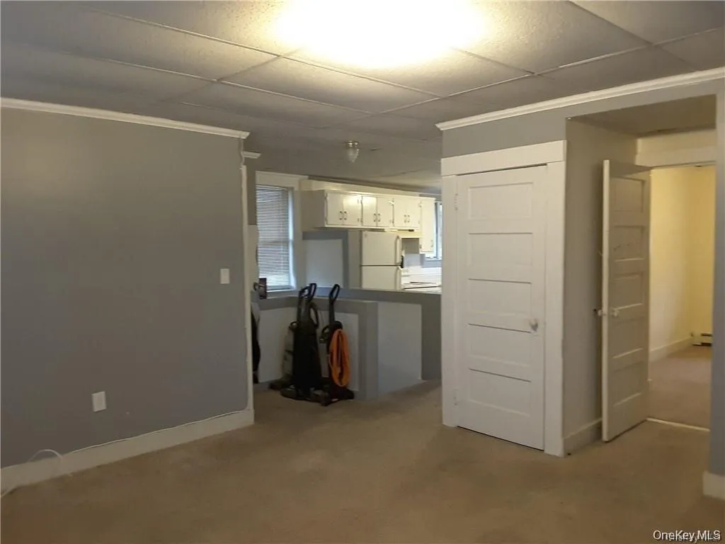 Living area featuring carpeting and light gray painted walls Living area featuring carpeting and light gray painted walls