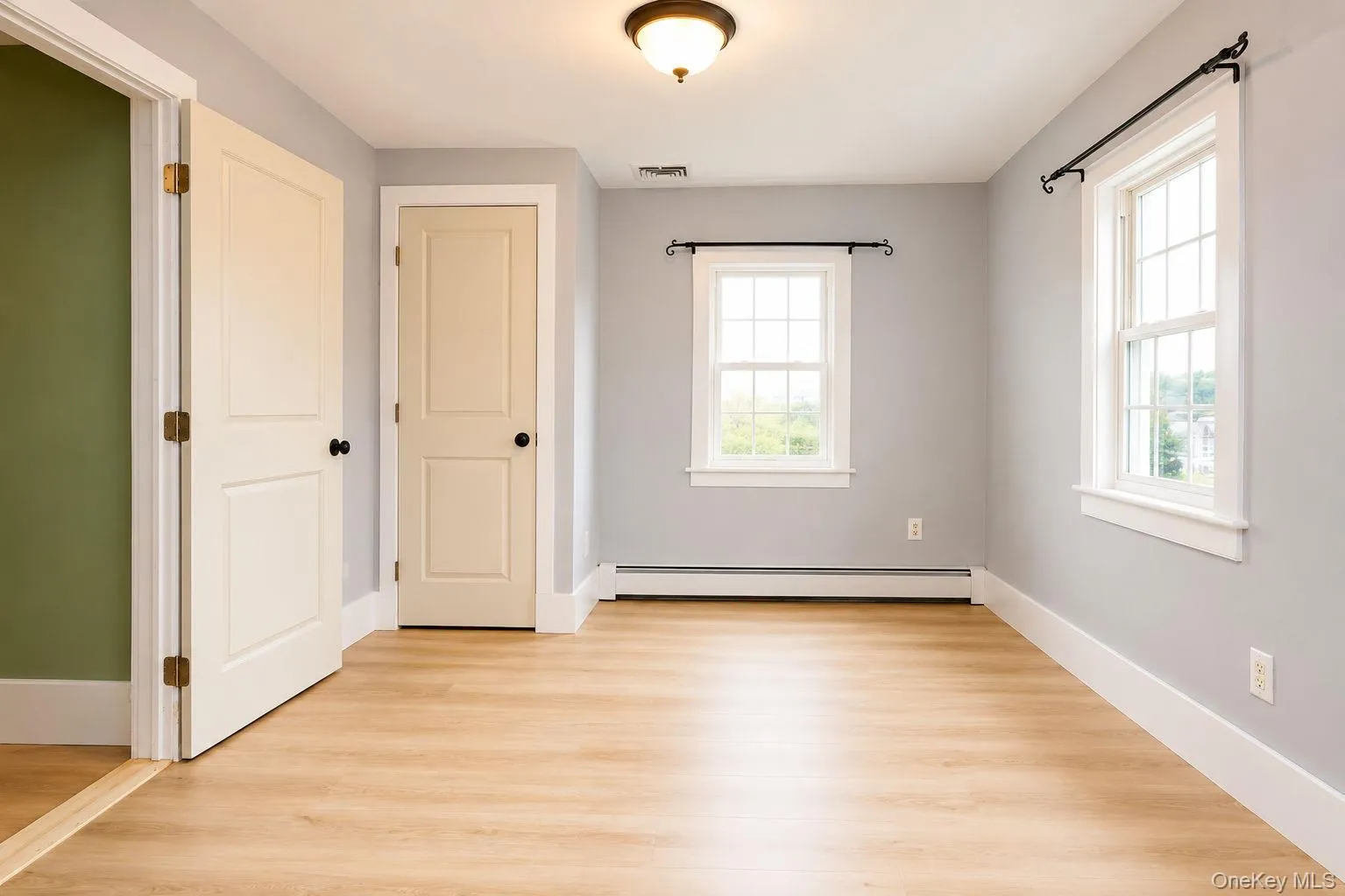 Bedroom off of the laundry room with vinyl plank flooring and closet Bedroom off of the laundry room with vinyl plank flooring and closet