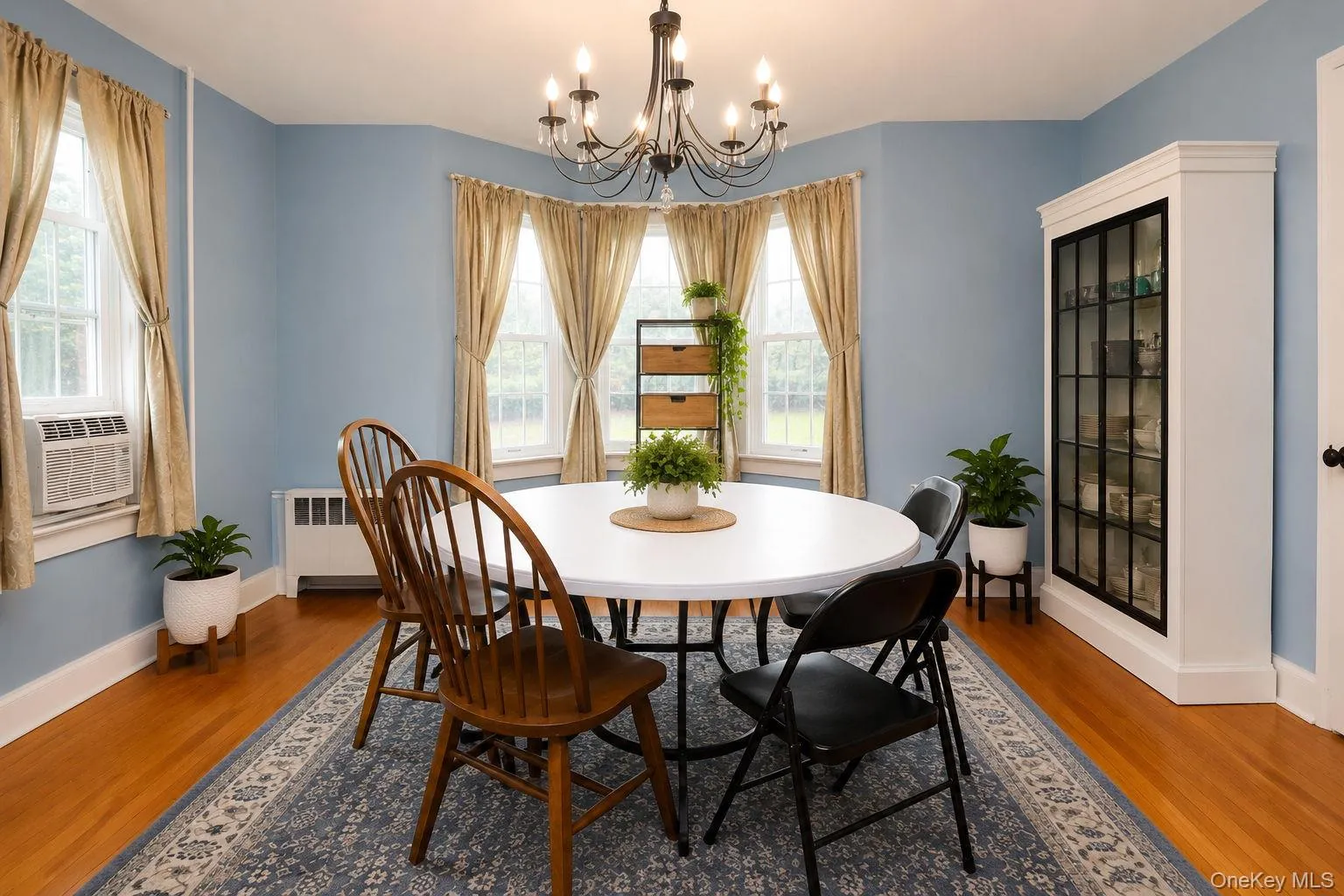 Formal dinning room with chandelier lighting, wood floors and china cabinet Formal dinning room with chandelier lighting, wood floors and china cabinet