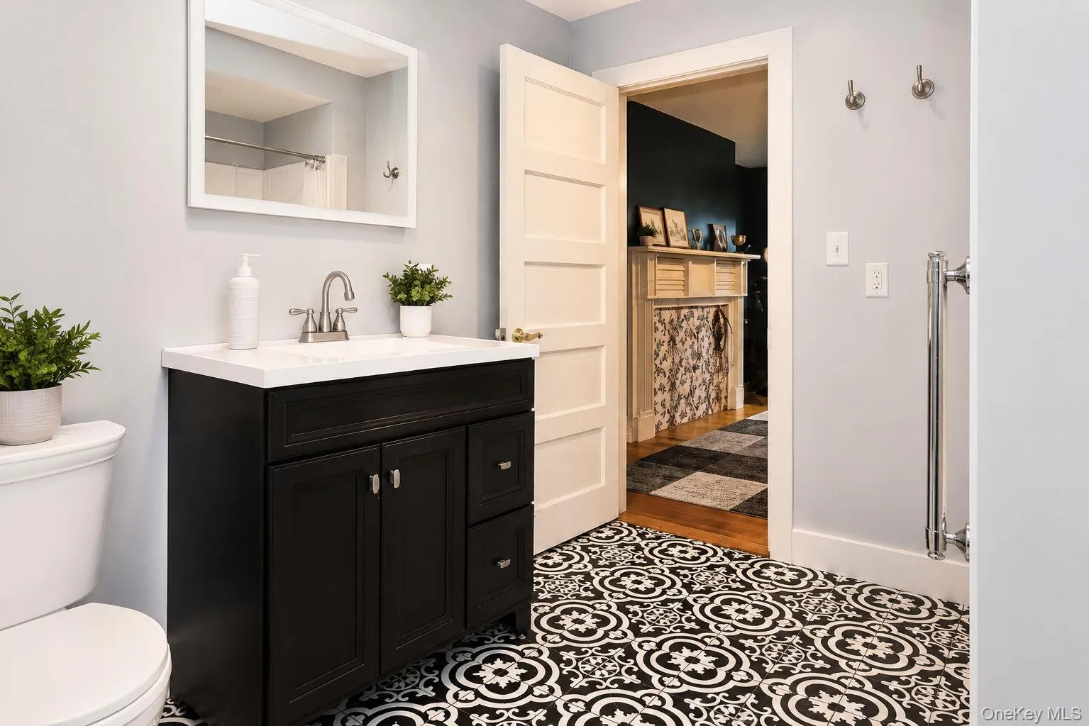 Bathroom with vanity, lighted mirror, tile flooring and view of the den Bathroom with vanity, lighted mirror, tile flooring and view of the den