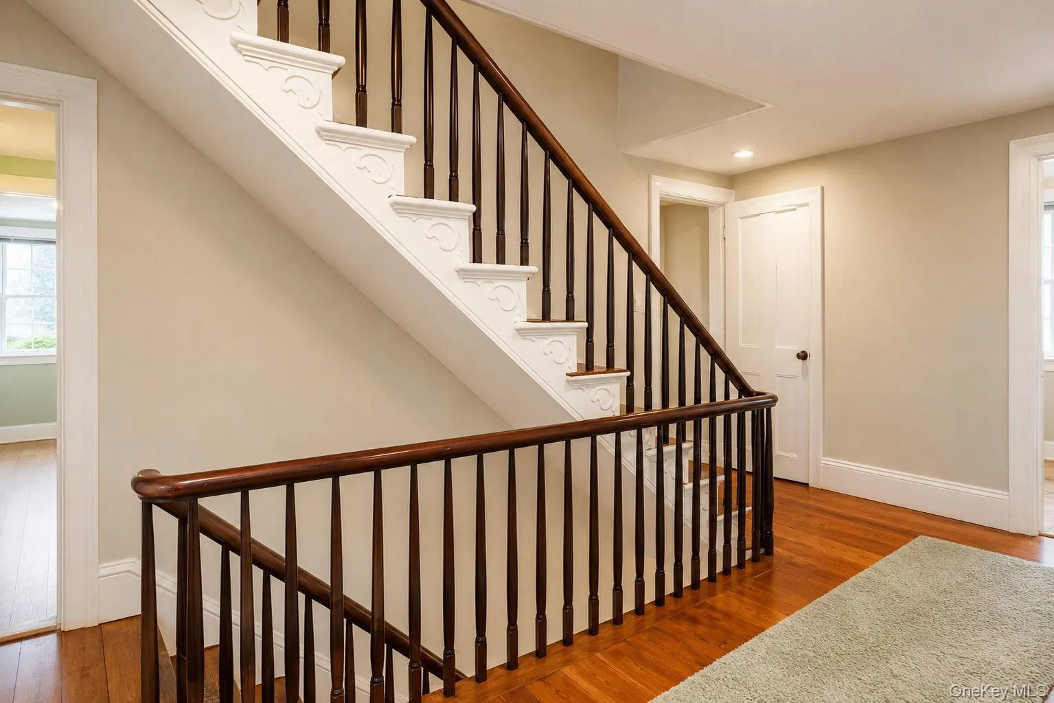 View of the stairway in the hall area to the attic and original wide wood plank flooring View of the stairway in the hall area to the attic and original wide wood plank flooring