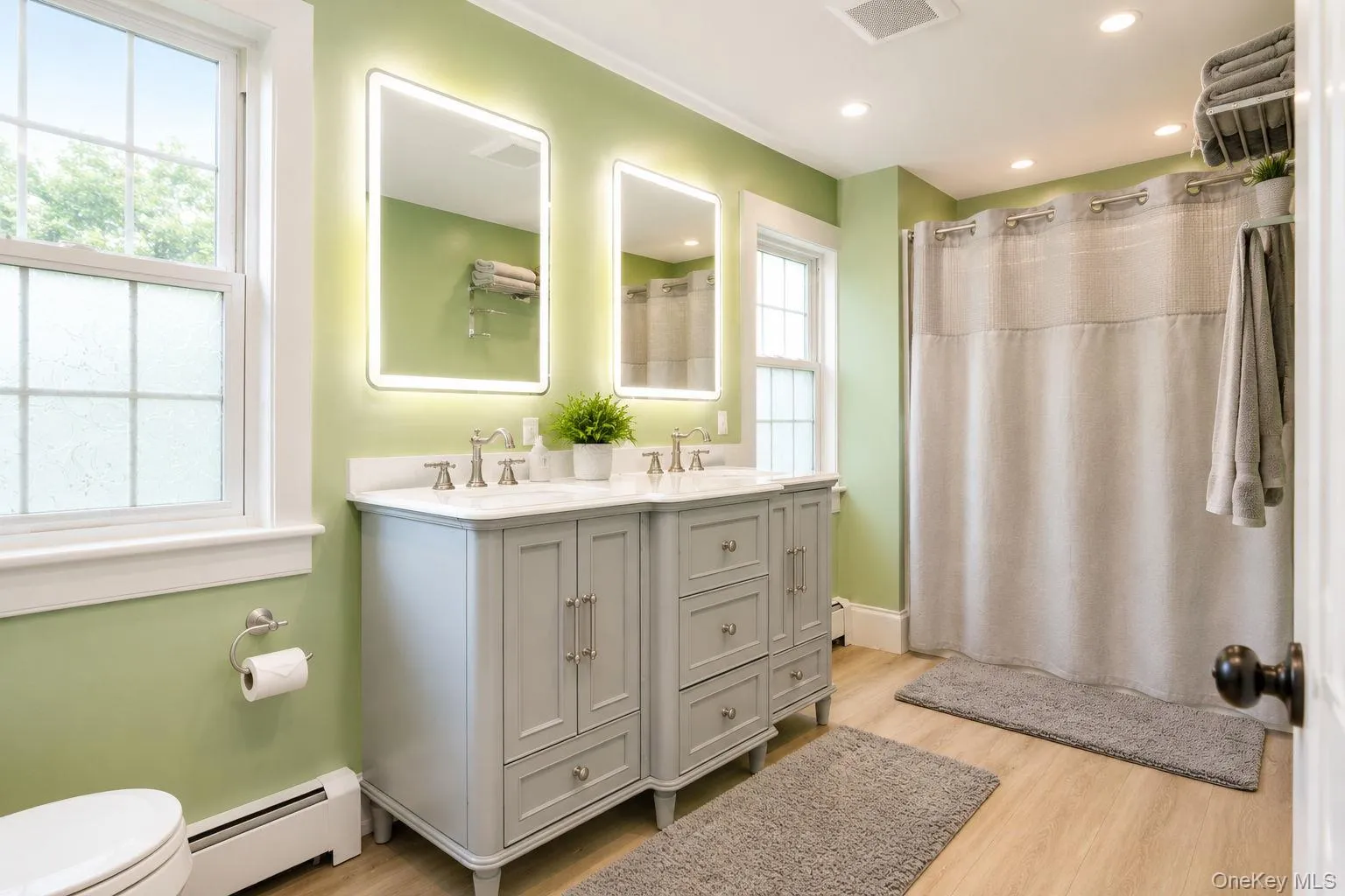 Updated second floor bathroom with double vanity, double lighted mirrors and shower with vinyl plank flooring Updated second floor bathroom with double vanity, double lighted mirrors and shower with vinyl plank flooring
