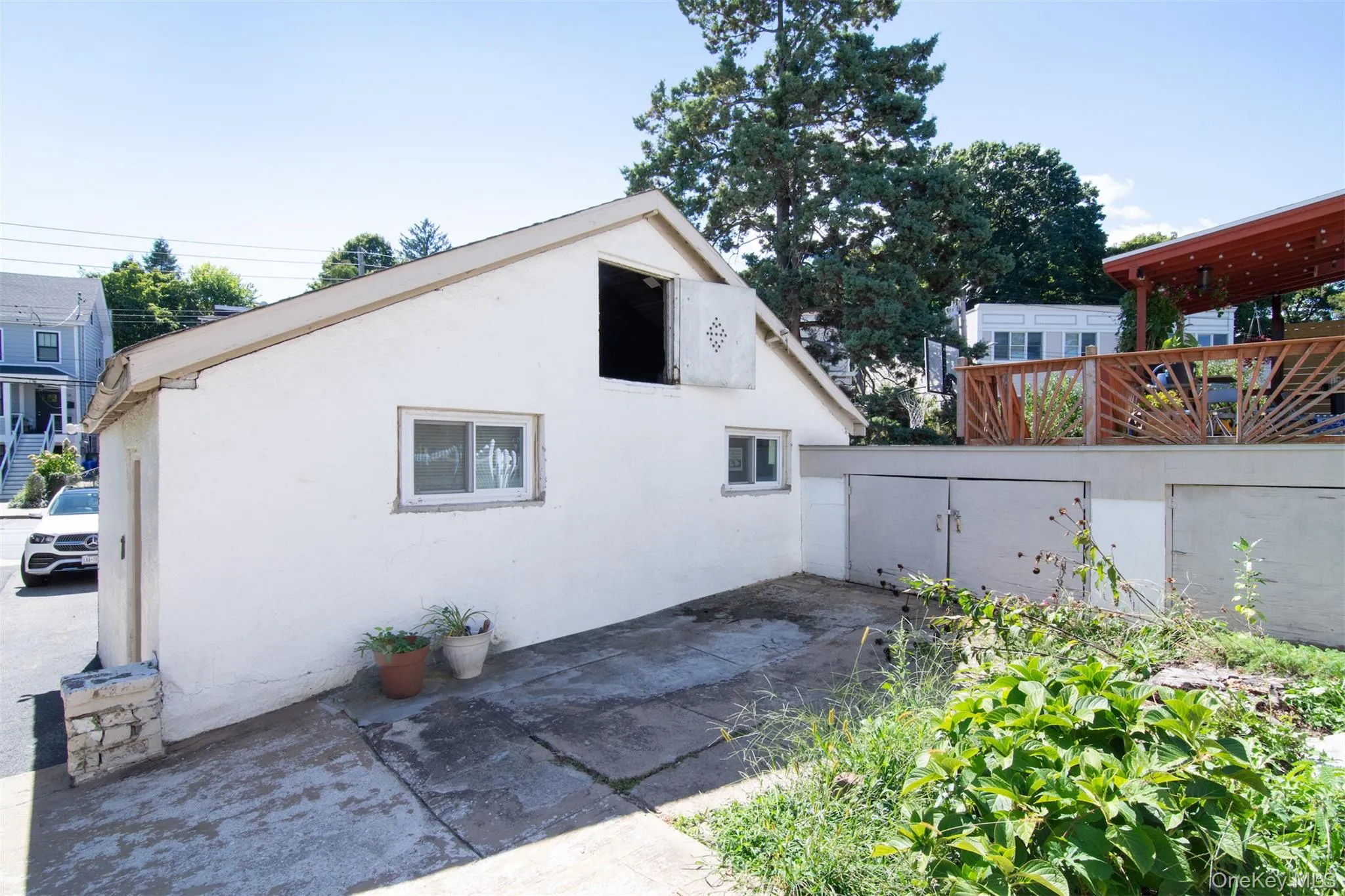 View of side of garage with a patio View of side of garage with a patio