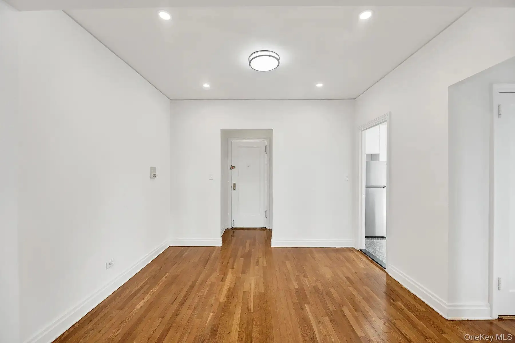 Hardwood flooring throughout, recessed lighting, and a contemporary ceiling fixture Hardwood flooring throughout, recessed lighting, and a contemporary ceiling fixture