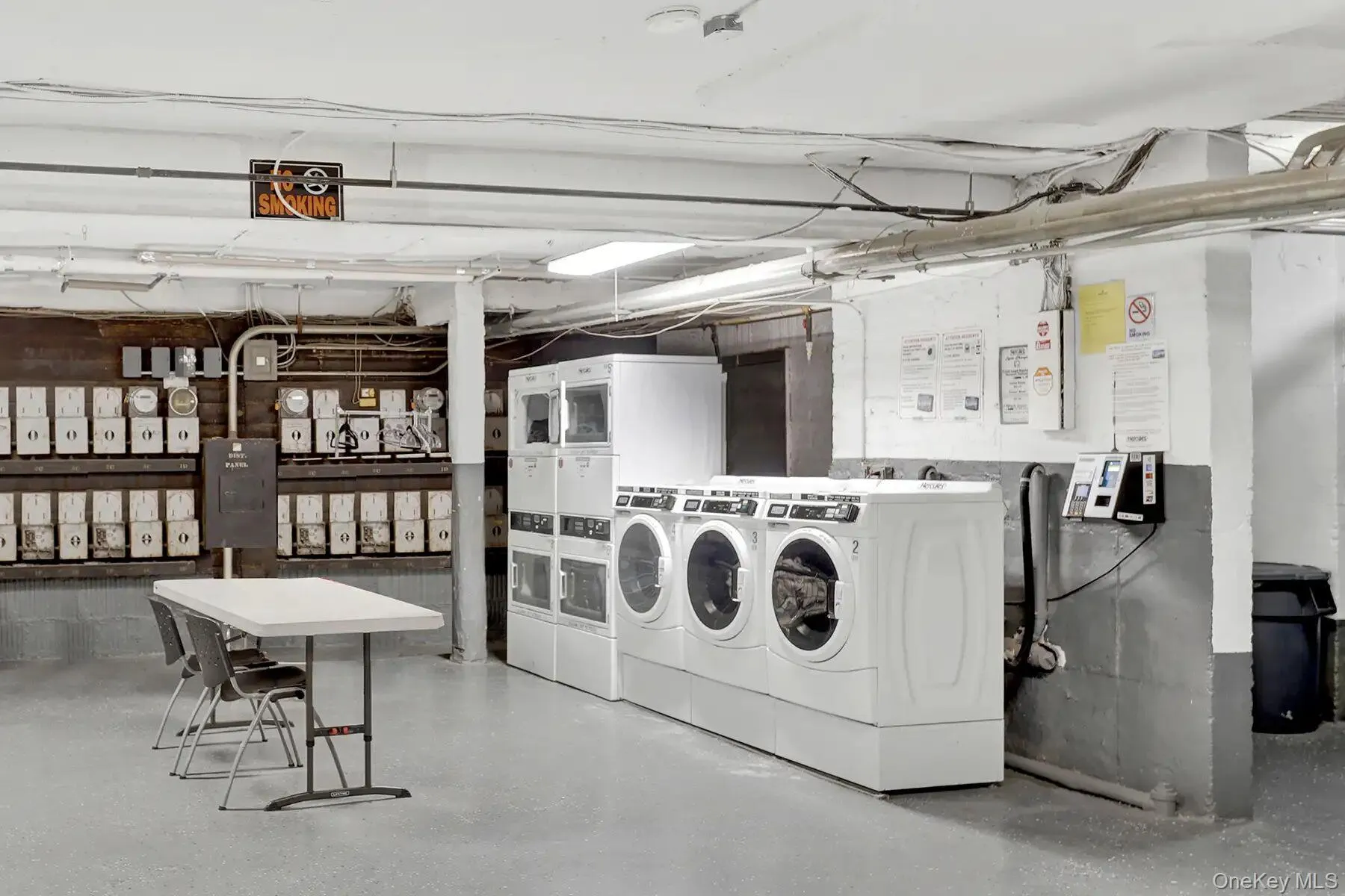 Dedicated laundry facility featuring multiple front-loading washers and dryers, utility sinks, and commercial-grade flooring Dedicated laundry facility featuring multiple front-loading washers and dryers, utility sinks, and commercial-grade flooring