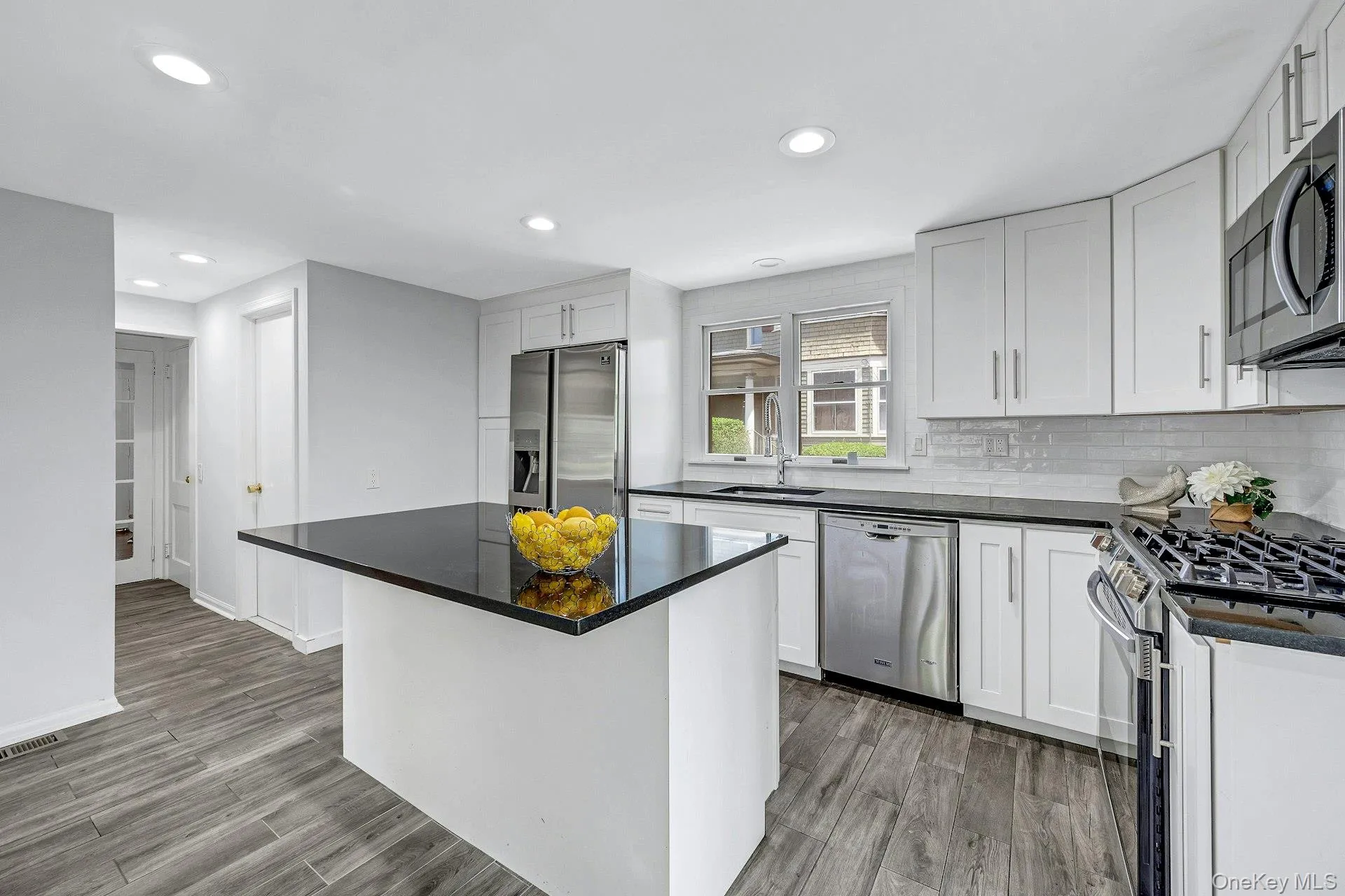 Kitchen with center island and stainless appliances and doors to yard Kitchen with center island and stainless appliances and doors to yard