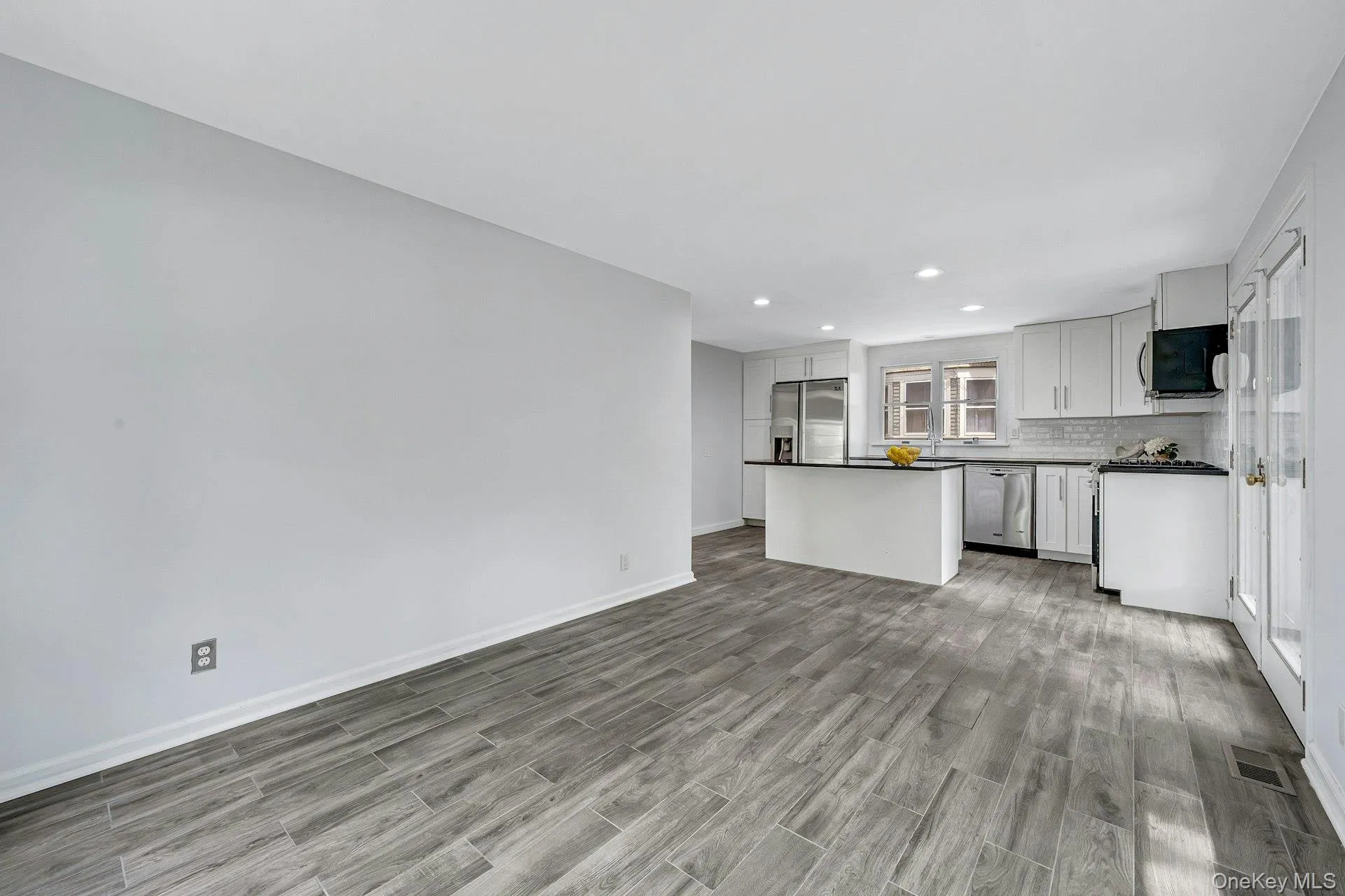 Kitchen with center island and stainless appliances and doors to yard Kitchen with center island and stainless appliances and doors to yard