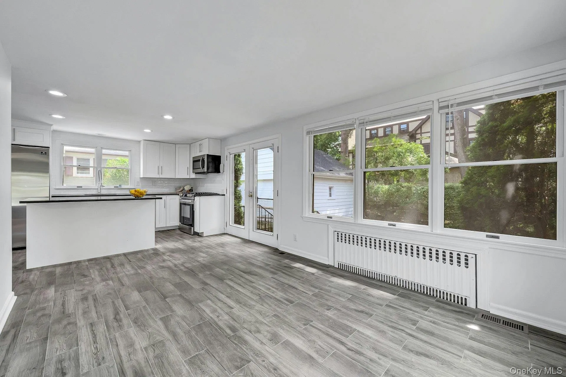Kitchen with center island and stainless appliances and doors to yard Kitchen with center island and stainless appliances and doors to yard