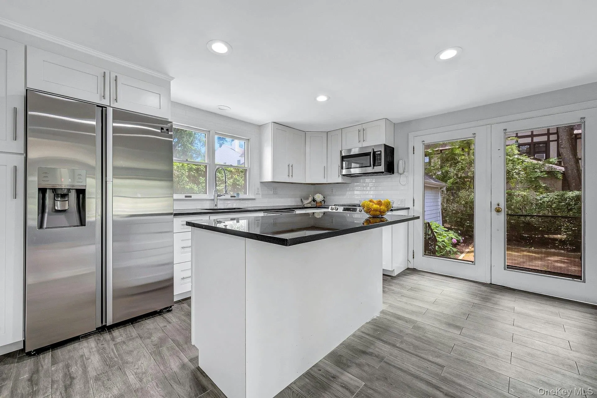 Kitchen with center island and stainless appliances and doors to yard Kitchen with center island and stainless appliances and doors to yard