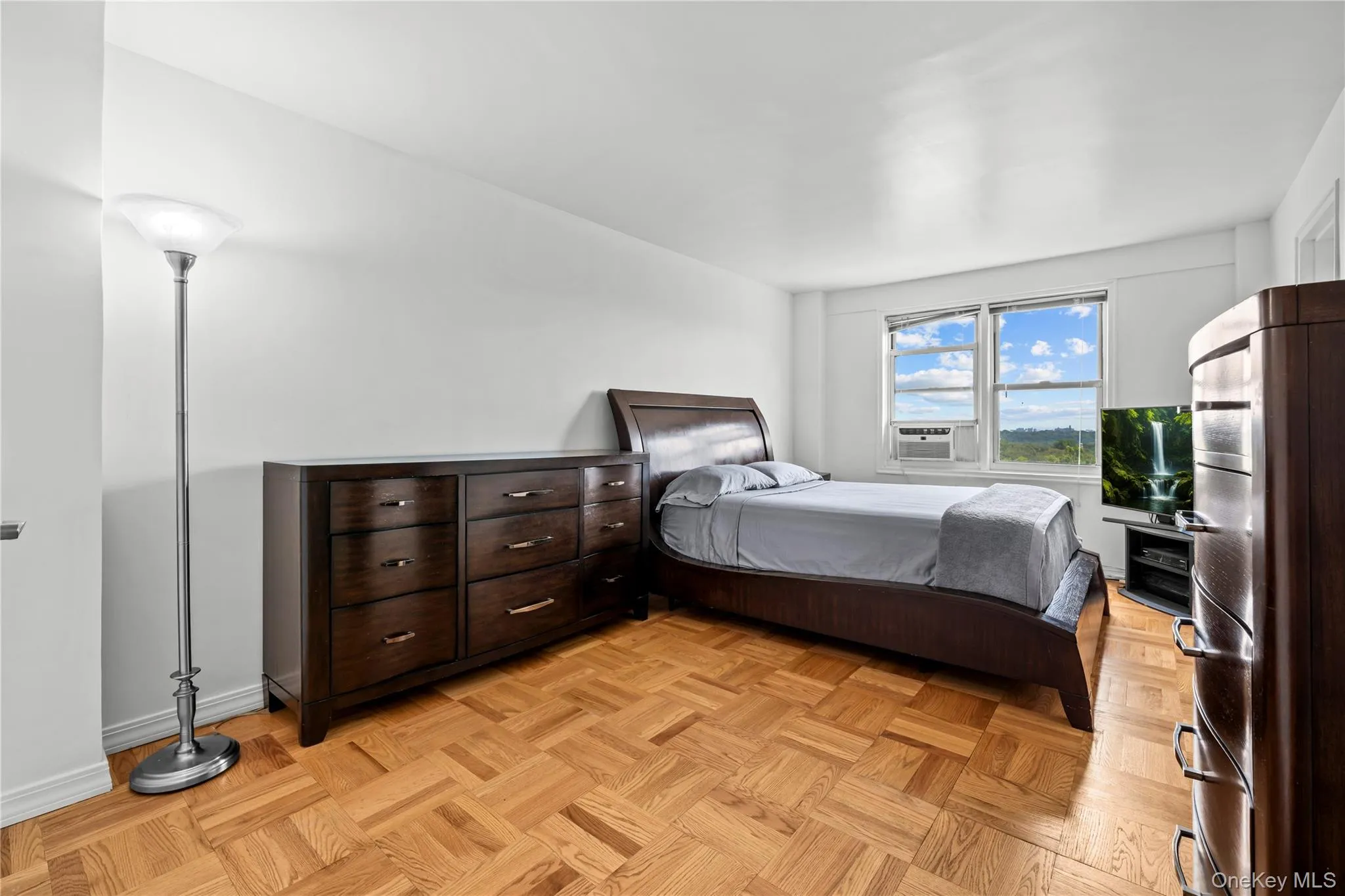 Windowed primary bedroom with access to balcony Windowed primary bedroom with access to balcony