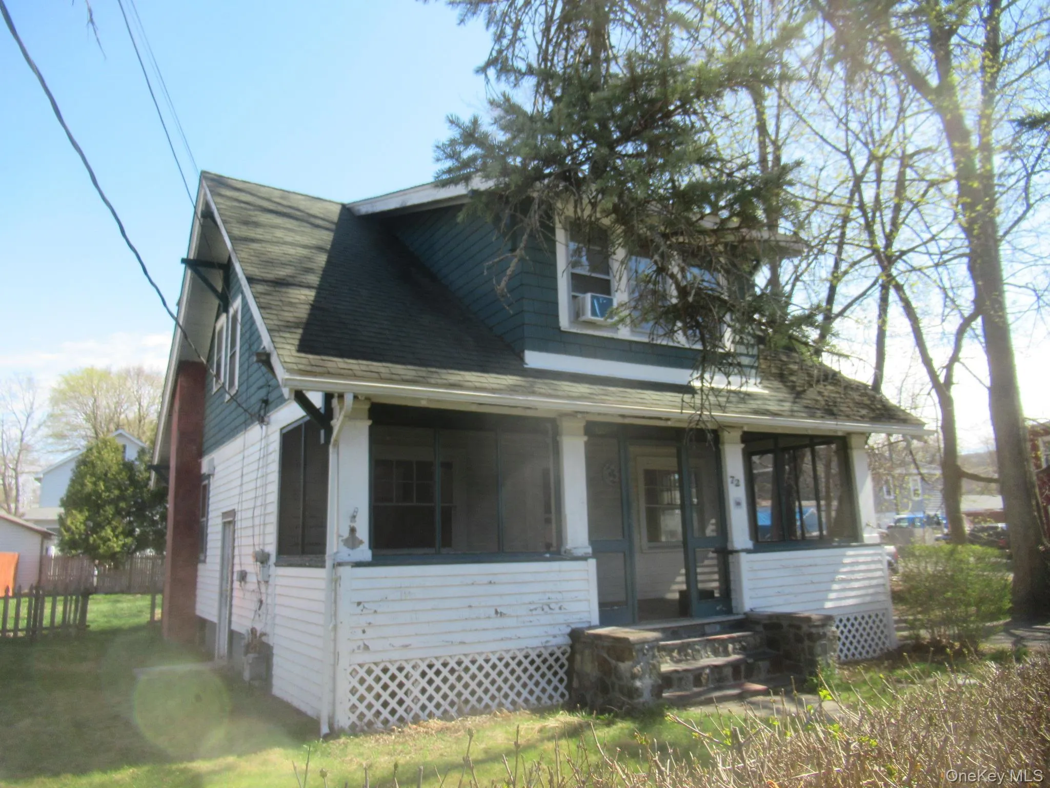 Two-story residence featuring a covered front porch with lattice detailing Two-story residence featuring a covered front porch with lattice detailing