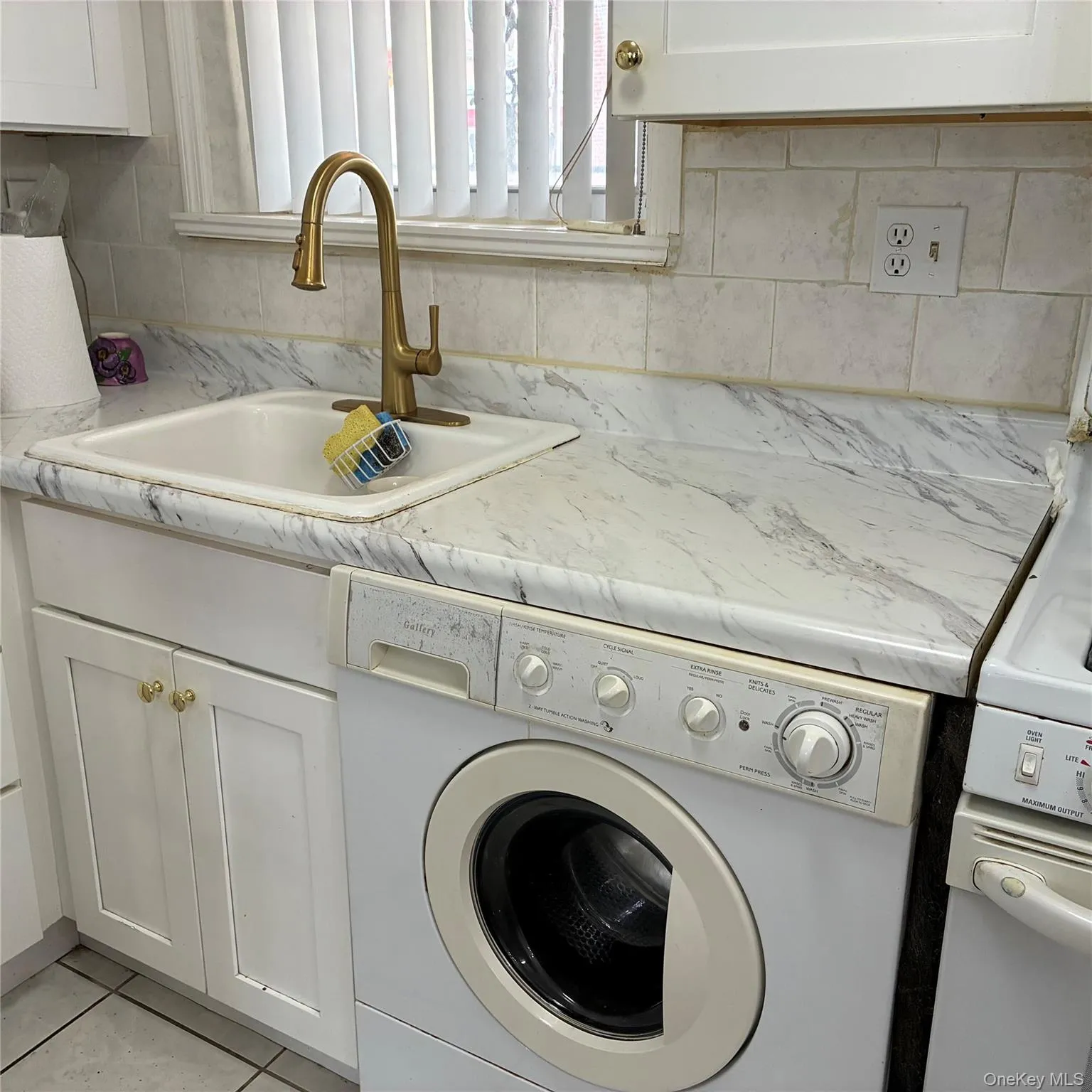 White appliances, including refrigerator, stove, microwave and washer White appliances, including refrigerator, stove, microwave and washer