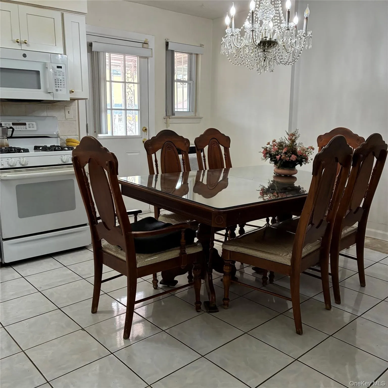 Updated eat-in kitchen with white appliances and room for a large dining room table Updated eat-in kitchen with white appliances and room for a large dining room table