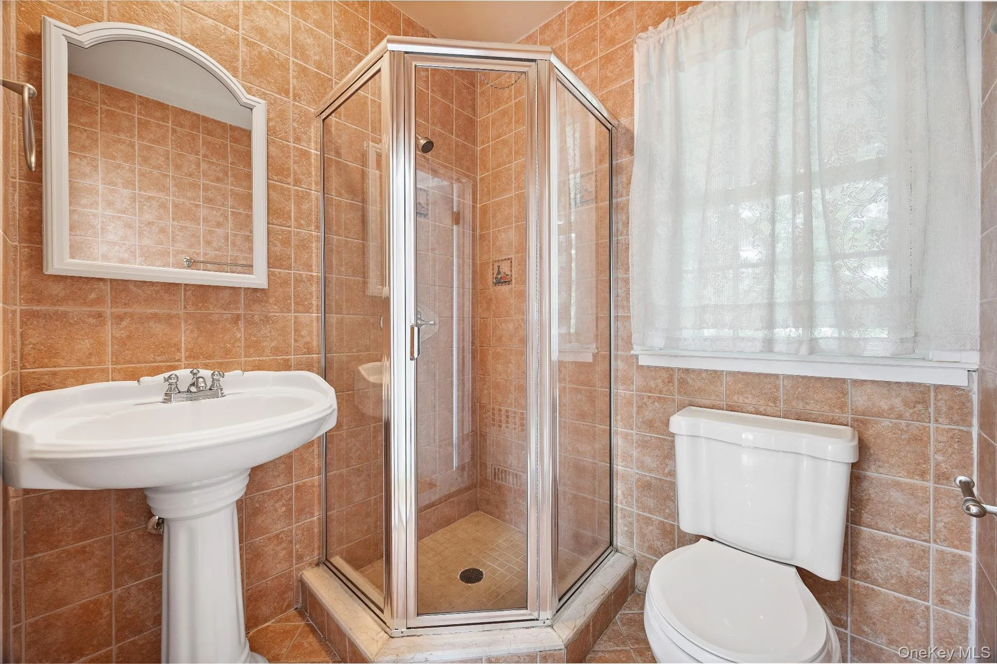 Bathroom featuring tile walls and a stall shower Bathroom featuring tile walls and a stall shower