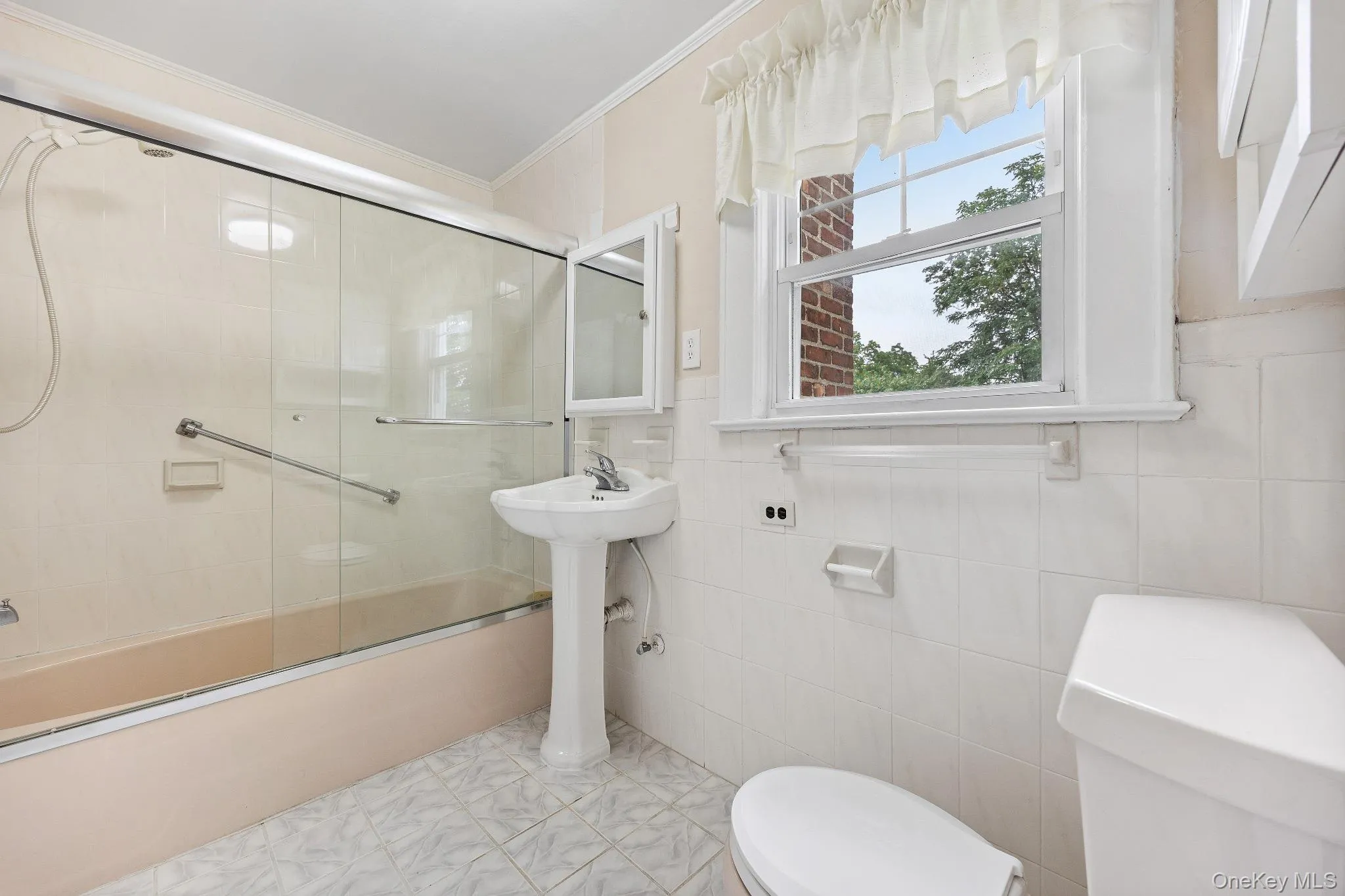 Full bath featuring crown molding and shower / bath combination with glass door Full bath featuring crown molding and shower / bath combination with glass door