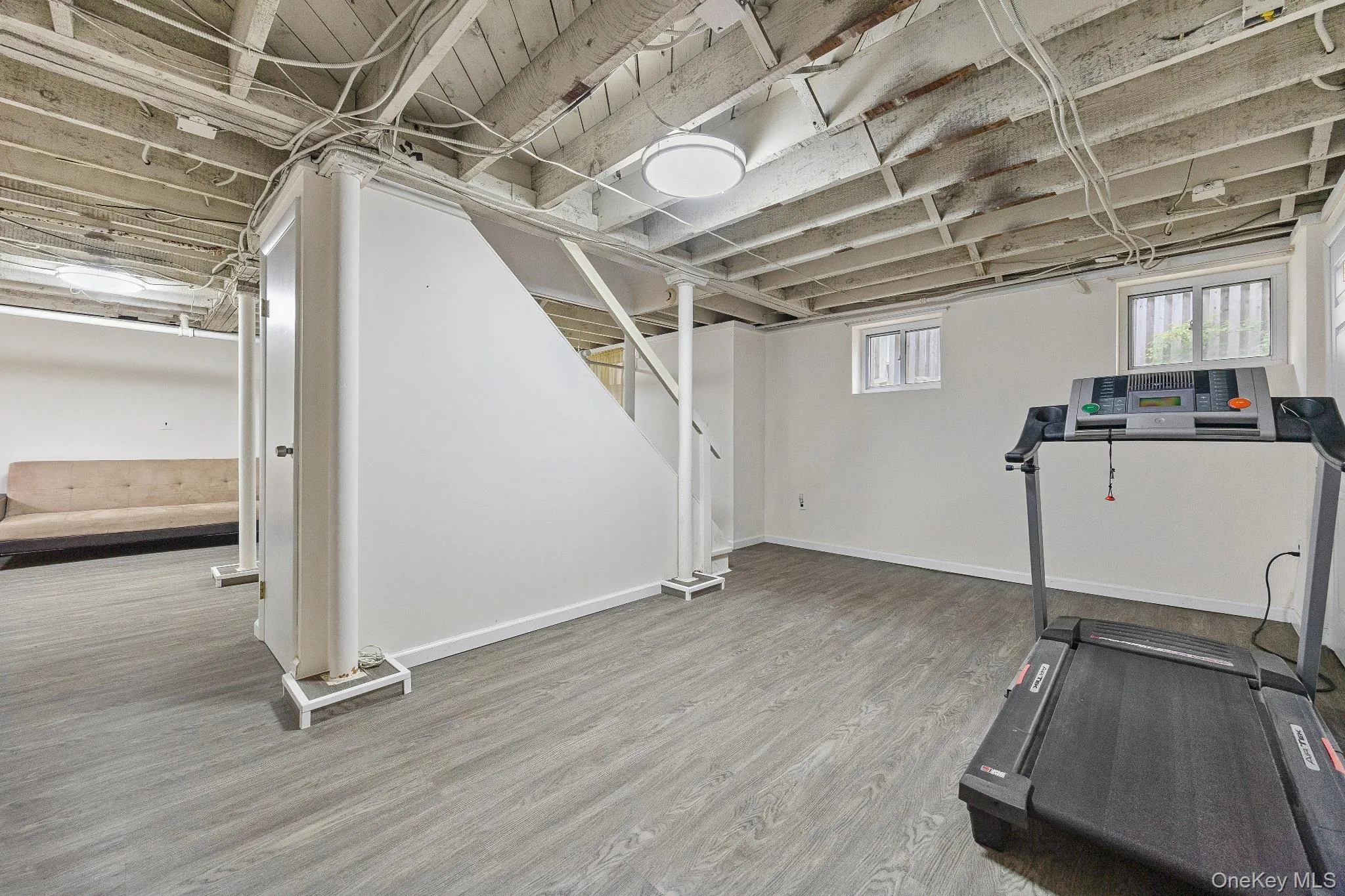 Exercise room with wood finished floors and baseboards Exercise room with wood finished floors and baseboards