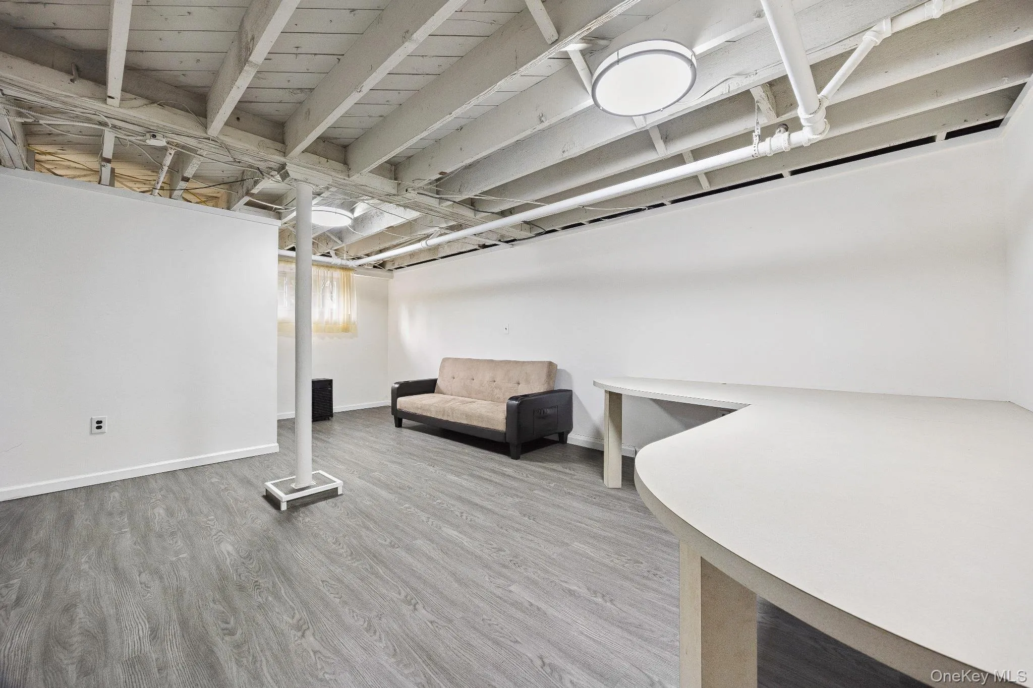 Finished basement featuring wood finished floors and baseboards Finished basement featuring wood finished floors and baseboards