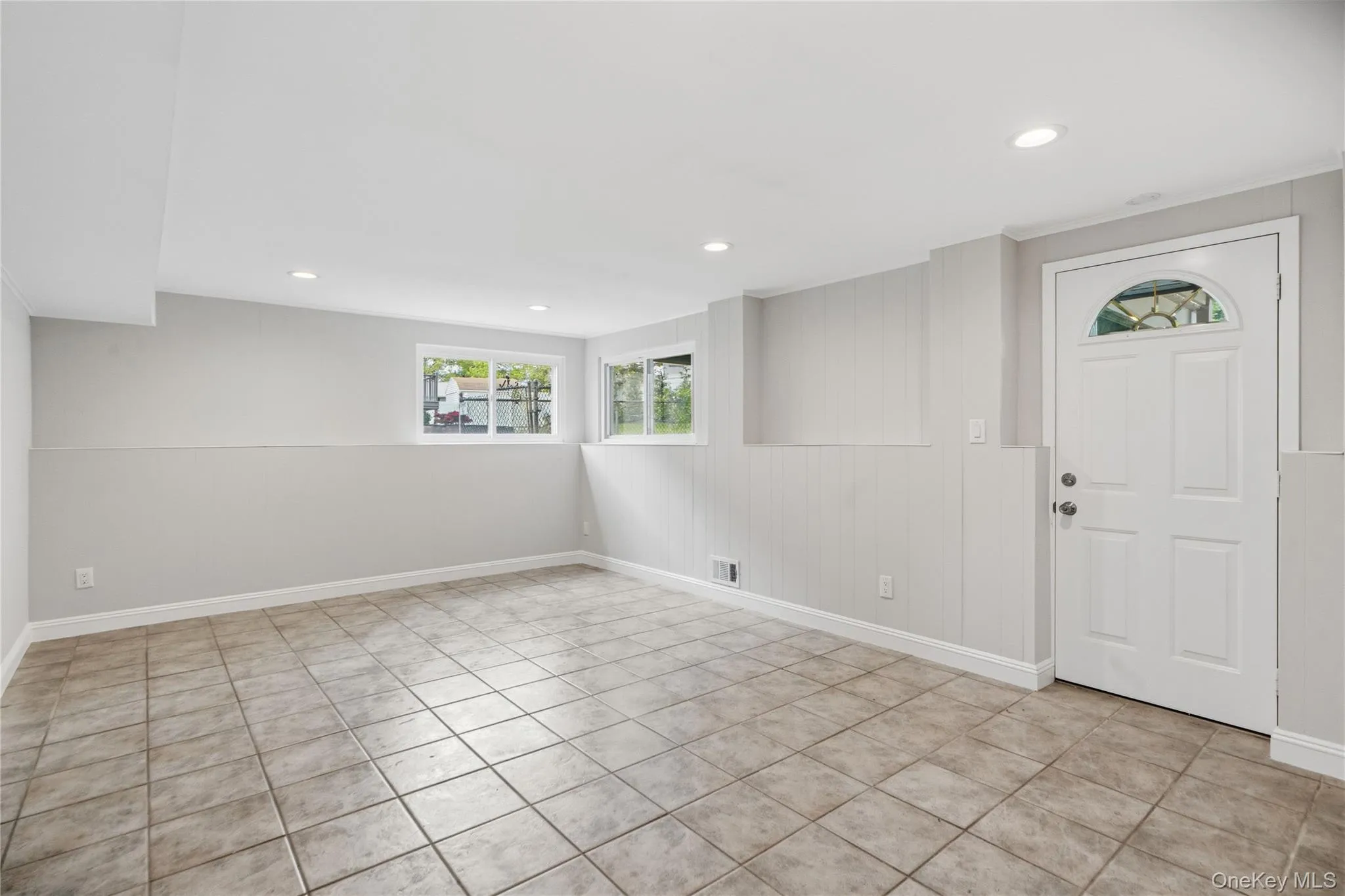 Spacious room featuring neutral tone ceramic tile flooring and light gray walls with recessed lighting, Spacious room featuring neutral tone ceramic tile flooring and light gray walls with recessed lighting,