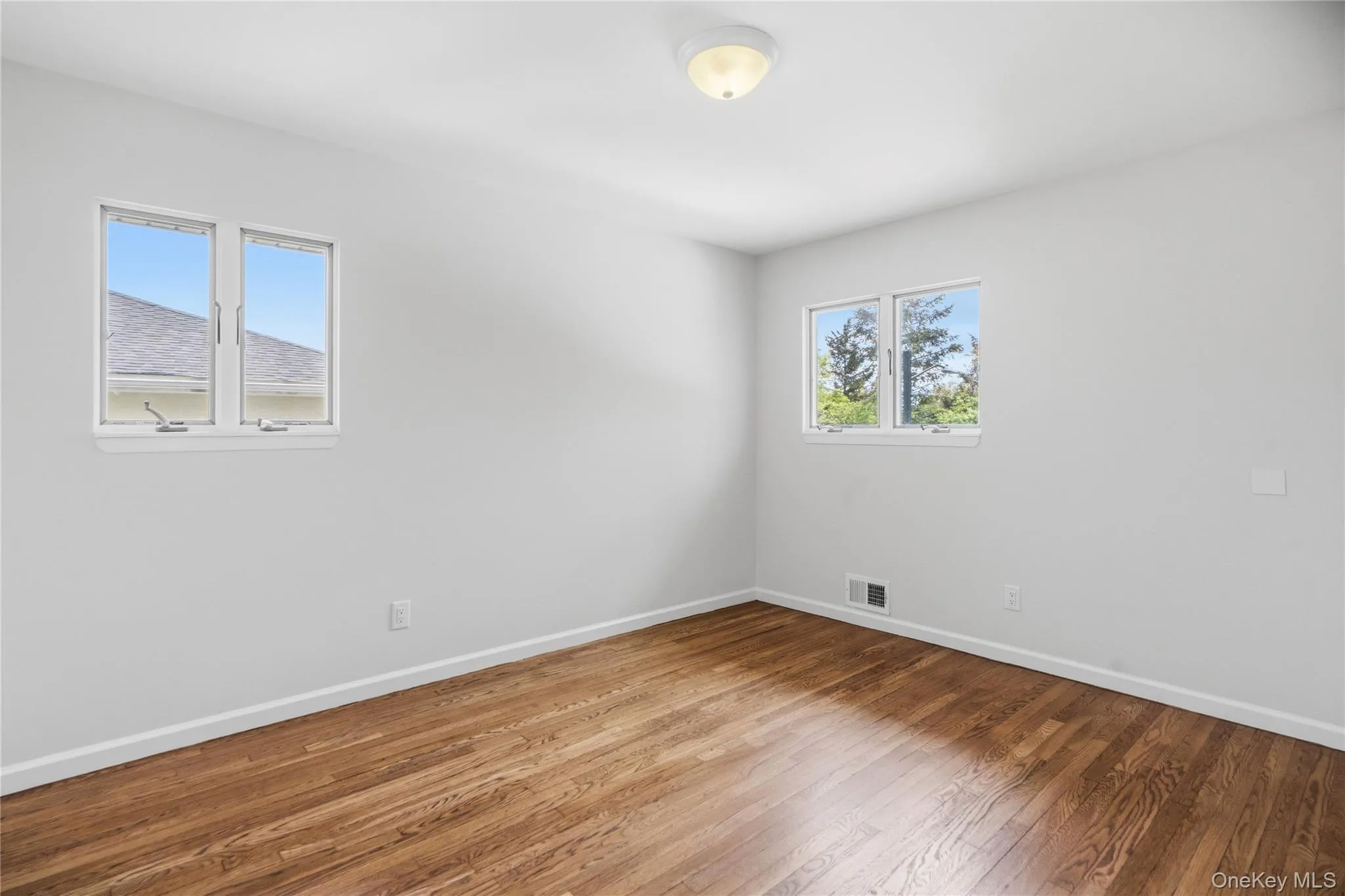Second Bedroom with Hardwood flooring with white baseboards Second Bedroom with Hardwood flooring with white baseboards