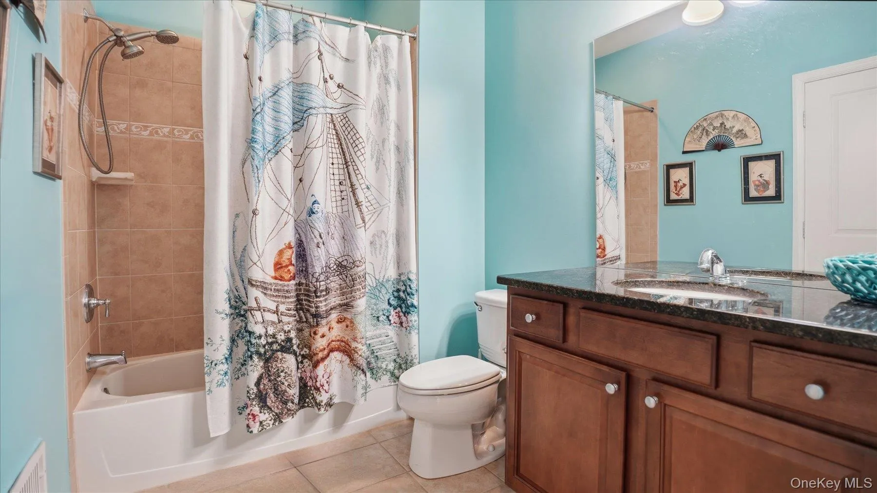 Guest Bathroom featuring a dark wood-finish vanity with a dark speckled countertop, an undermount sink, and chrome fixtures Guest Bathroom featuring a dark wood-finish vanity with a dark speckled countertop, an undermount sink, and chrome fixtures
