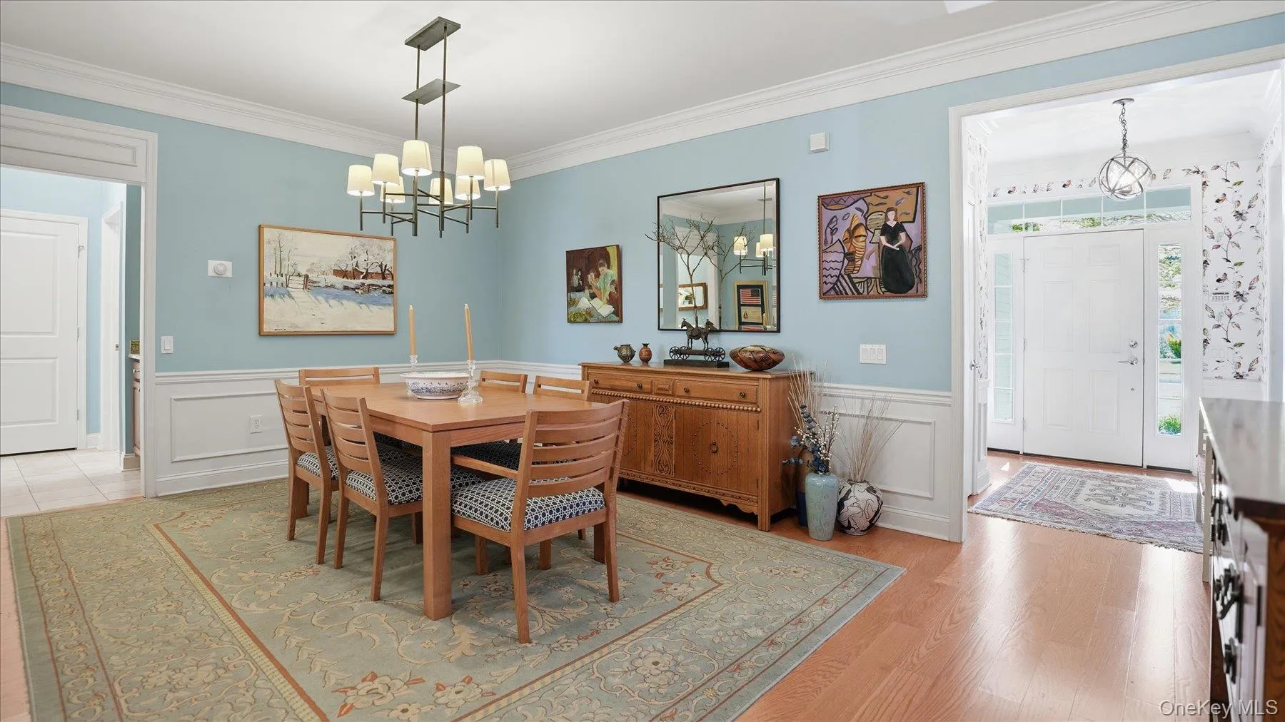 Formal dining area featuring light wood-finish flooring and an ornate area rug Formal dining area featuring light wood-finish flooring and an ornate area rug