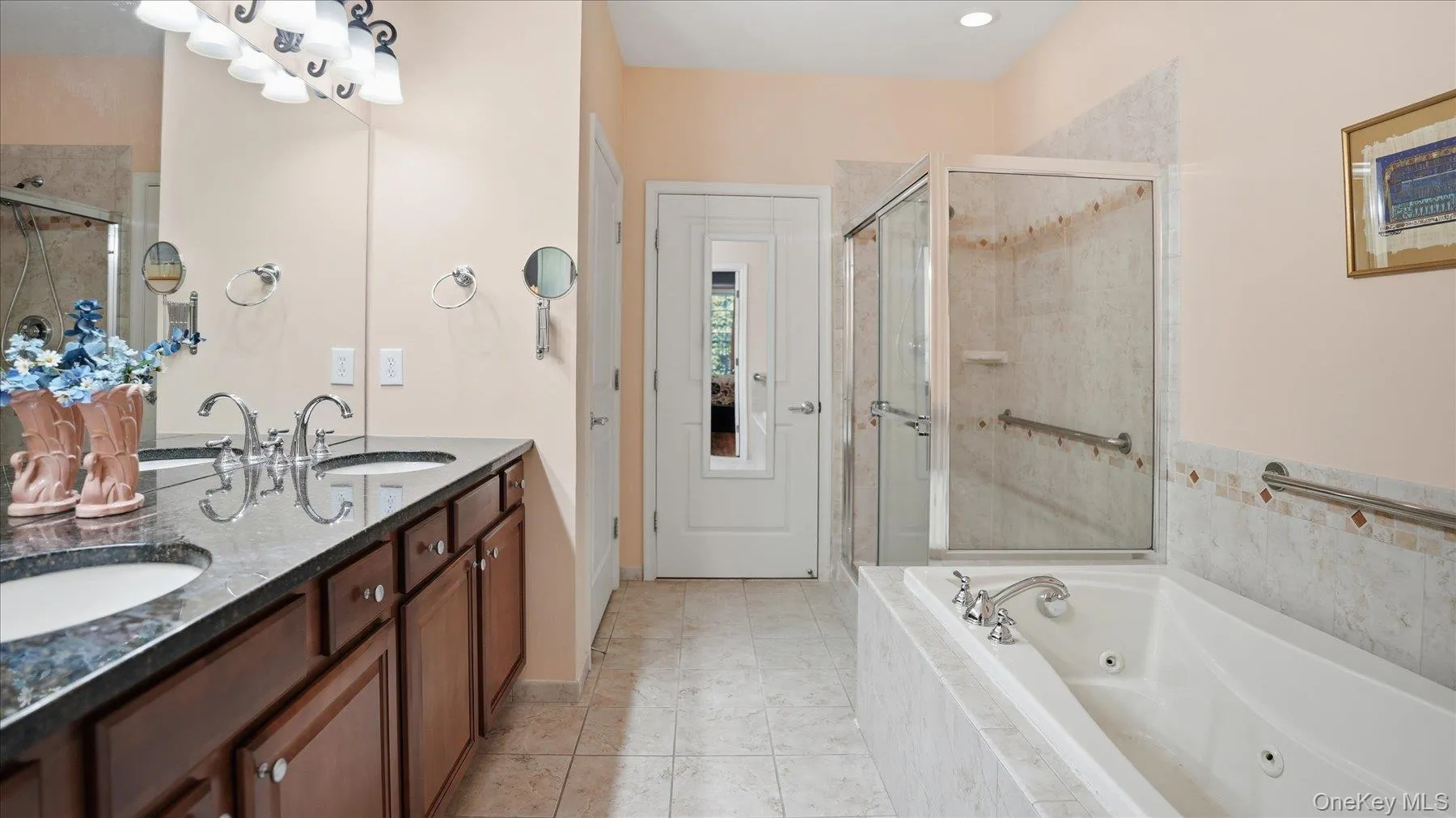 Double vanity with granite countertop and undermount sinks, separate jacuzzi soaking tub, water closet, enclosed shower and entrance to walk-in-closet Double vanity with granite countertop and undermount sinks, separate jacuzzi soaking tub, water closet, enclosed shower and entrance to walk-in-closet