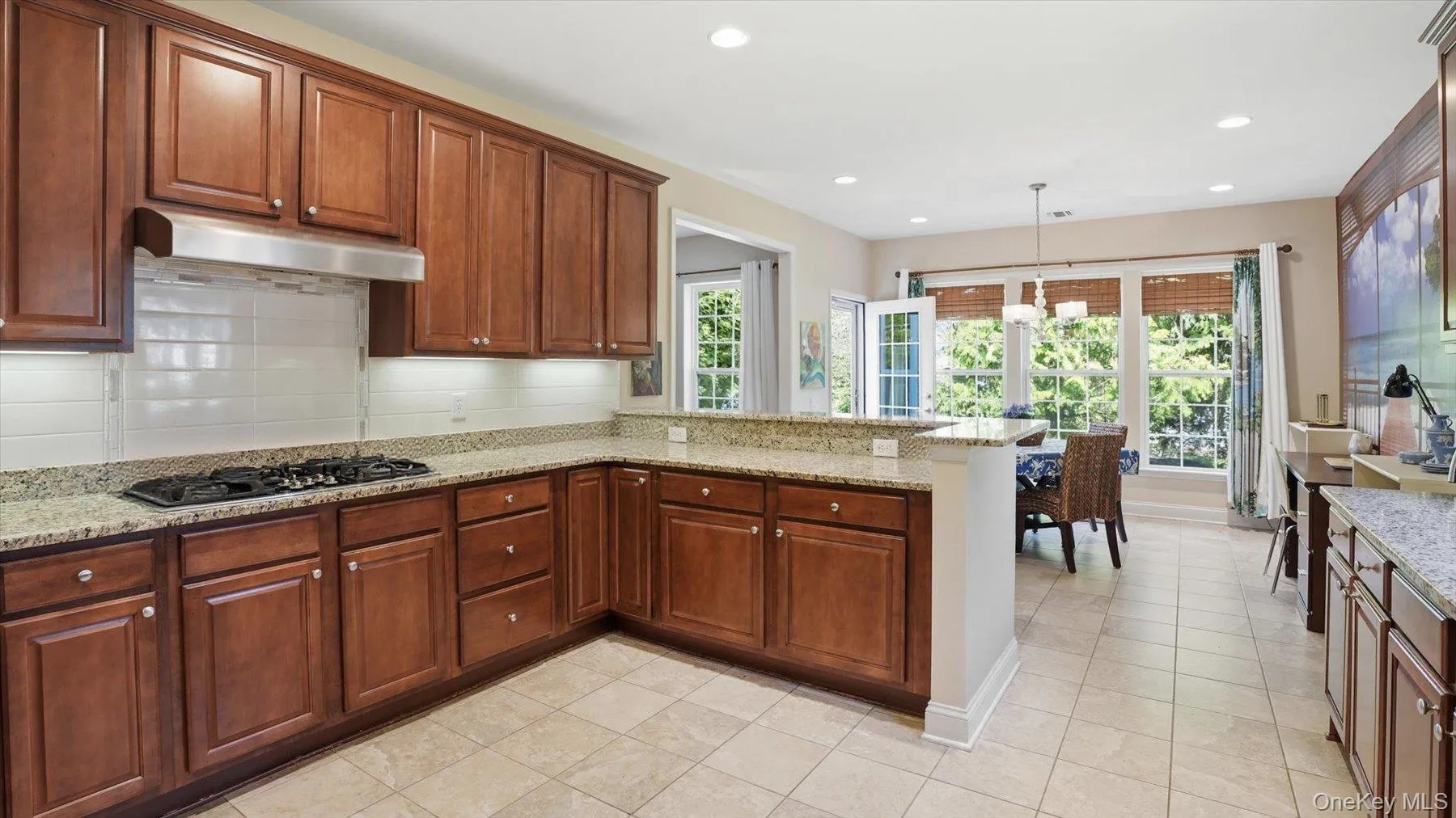 Kitchen featuring a stainless steel range hood, and under-cabinet lighting Kitchen featuring a stainless steel range hood, and under-cabinet lighting