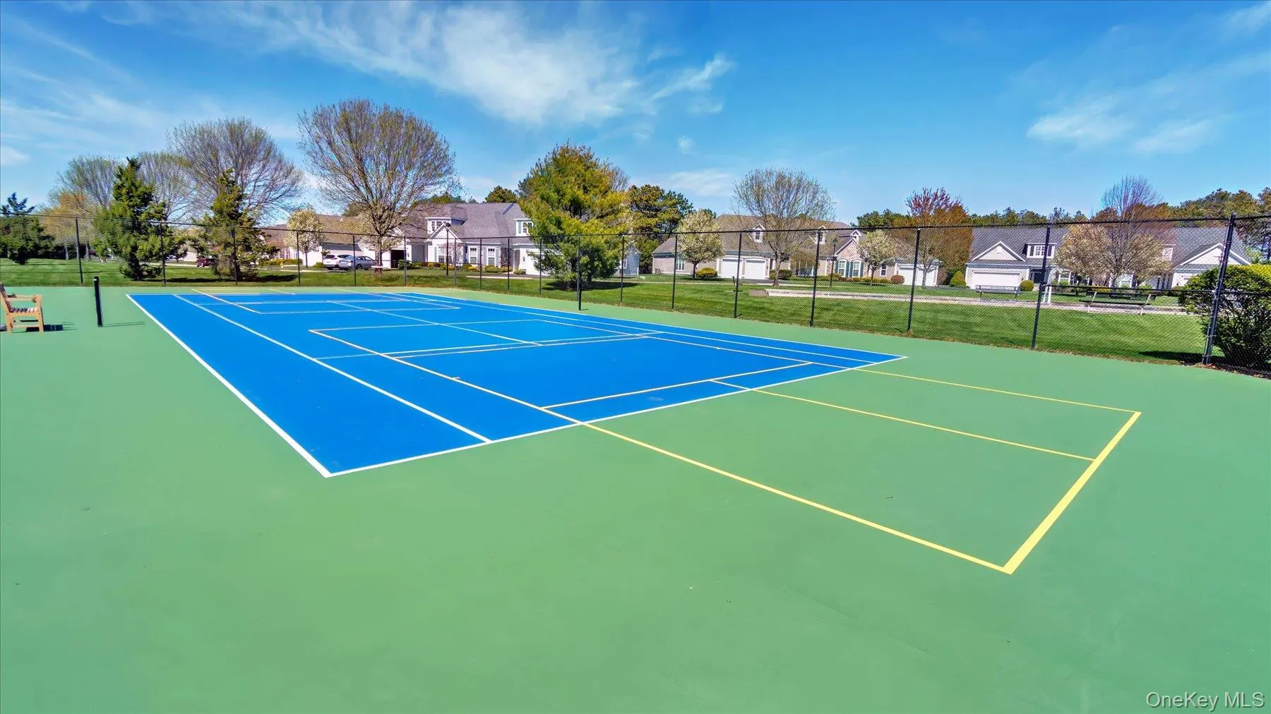 Tennis court with a blue playing surface and Pickleball court Tennis court with a blue playing surface and Pickleball court