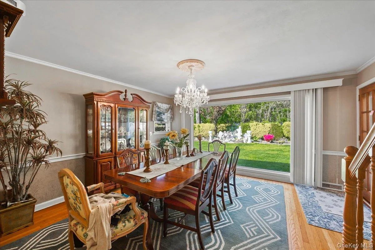 Hardwood flooring complements a chandelier and crown molding Hardwood flooring complements a chandelier and crown molding