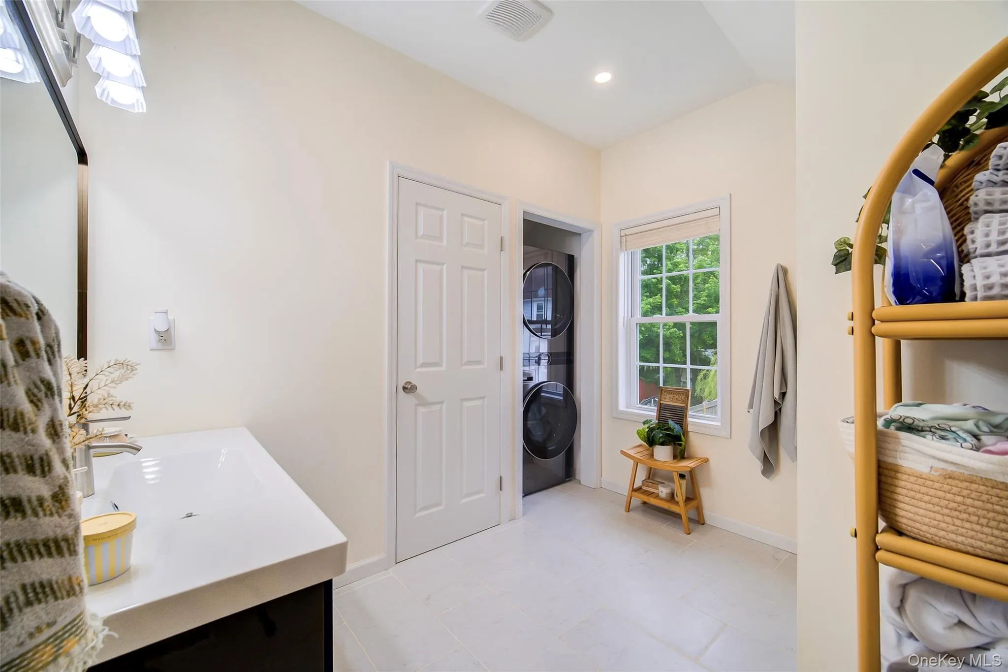 Bathroom featuring a single vanity with an integrated sink, polished chrome faucet, and dark wood-finish cabinetry Bathroom featuring a single vanity with an integrated sink, polished chrome faucet, and dark wood-finish cabinetry