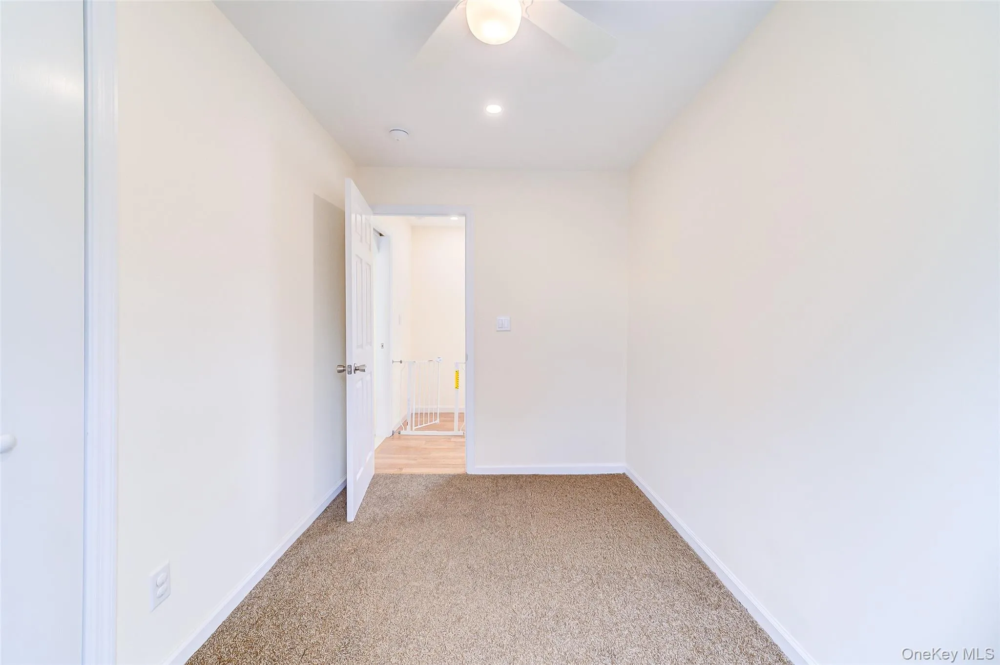 Bedroom featuring light-colored walls and neutral carpeting Bedroom featuring light-colored walls and neutral carpeting