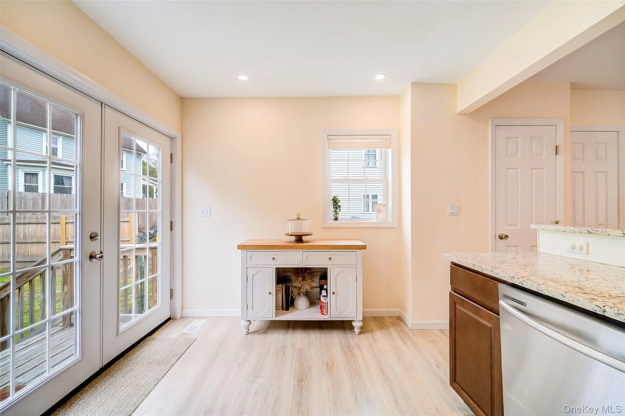 Kitchen area with light wood-finish flooring and cream-colored walls Kitchen area with light wood-finish flooring and cream-colored walls