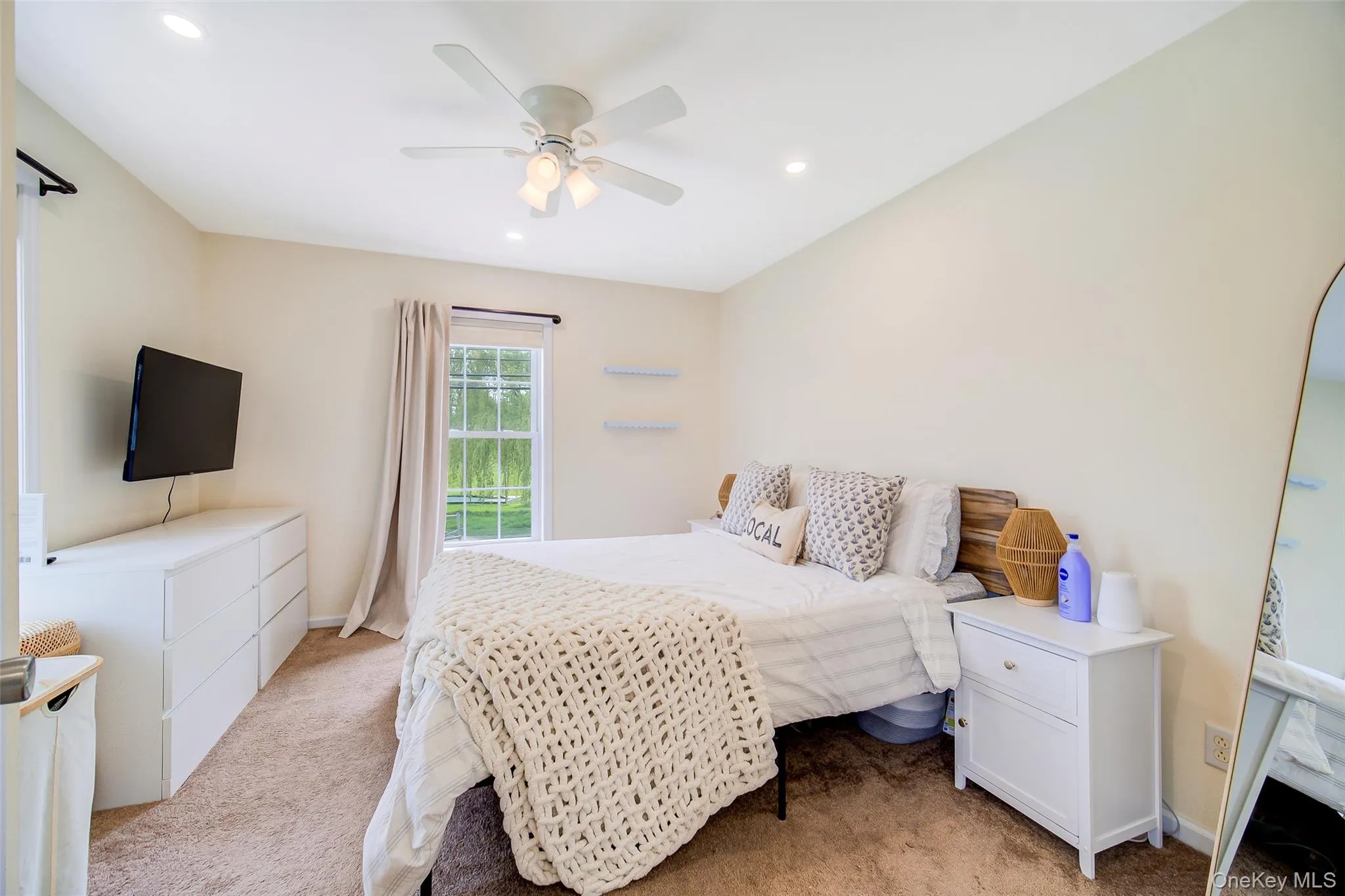 Bedroom featuring wall-to-wall carpeting, recessed lighting, and a ceiling fan with light fixture Bedroom featuring wall-to-wall carpeting, recessed lighting, and a ceiling fan with light fixture