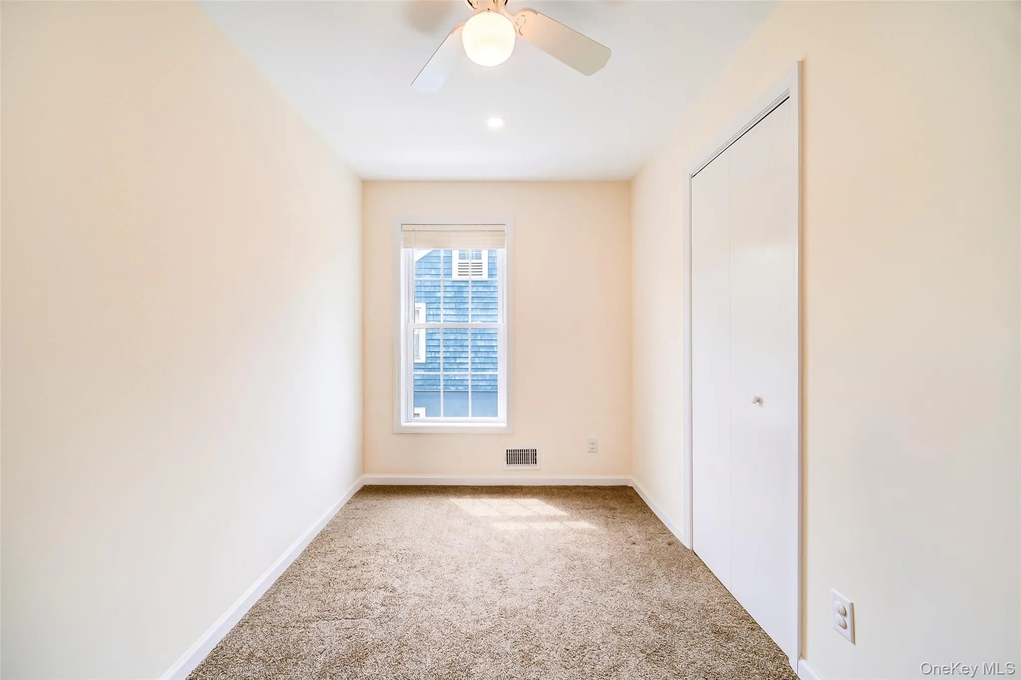 Bedroom with light neutral walls and brown carpet flooring Bedroom with light neutral walls and brown carpet flooring