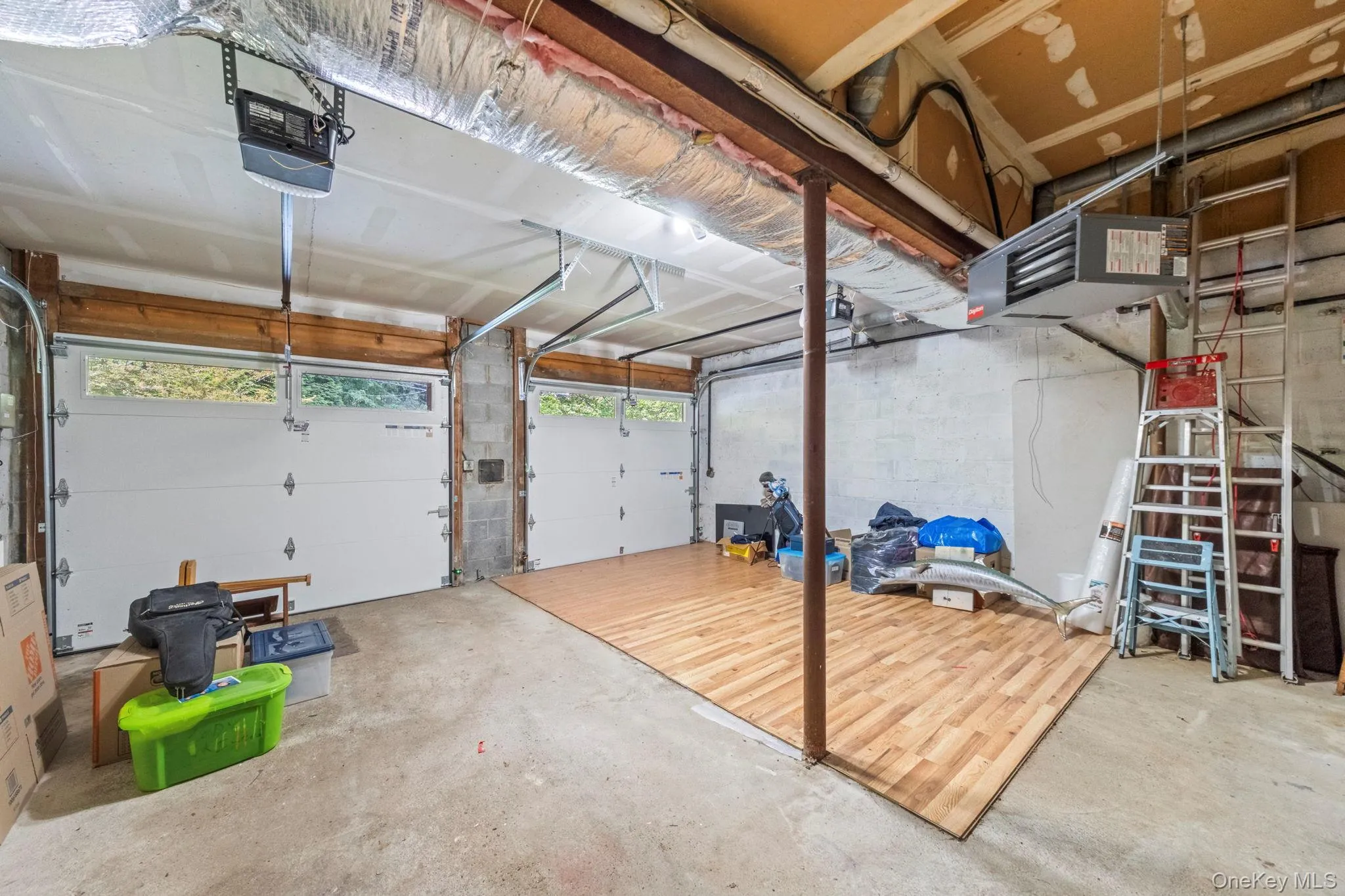Spacious two-car garage featuring automatic openers and transom window panels. Garage includes built in storage cabinets Spacious two-car garage featuring automatic openers and transom window panels. Garage includes built in storage cabinets