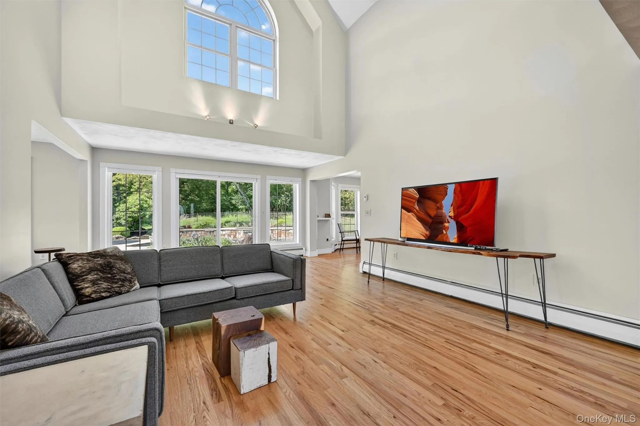 The living room is bright and dramatic, with tall ceilings, expansive windows, and a wonderful connection to the outdoor spaces beyond. The living room is bright and dramatic, with tall ceilings, expansive windows, and a wonderful connection to the outdoor spaces beyond.