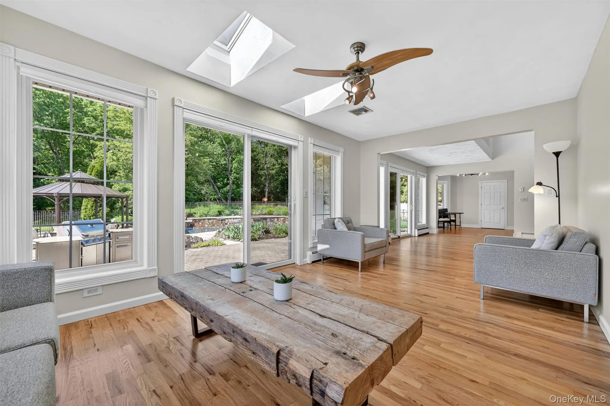 With skylights above and patio views just beyond the glass doors, this space is perfect for lounging, reading, or gathering with guests. With skylights above and patio views just beyond the glass doors, this space is perfect for lounging, reading, or gathering with guests.