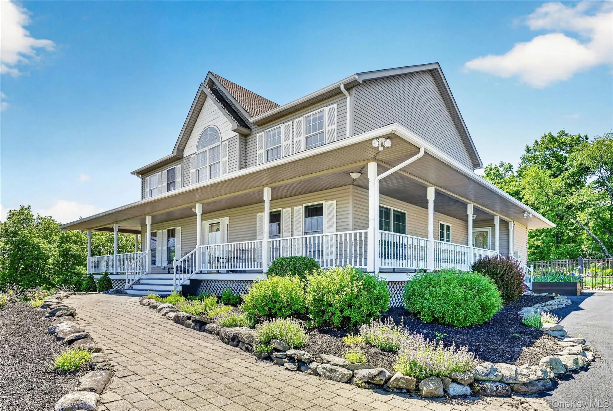 The front walkway and wraparound porch create a warm welcome, offering the kind of entry that instantly feels like home. Beautifully manicured flower beds relfect how well this home has been cared for inside and out. The front walkway and wraparound porch create a warm welcome, offering the kind of entry that instantly feels like home. Beautifully manicured flower beds relfect how well this home has been cared for inside and out.