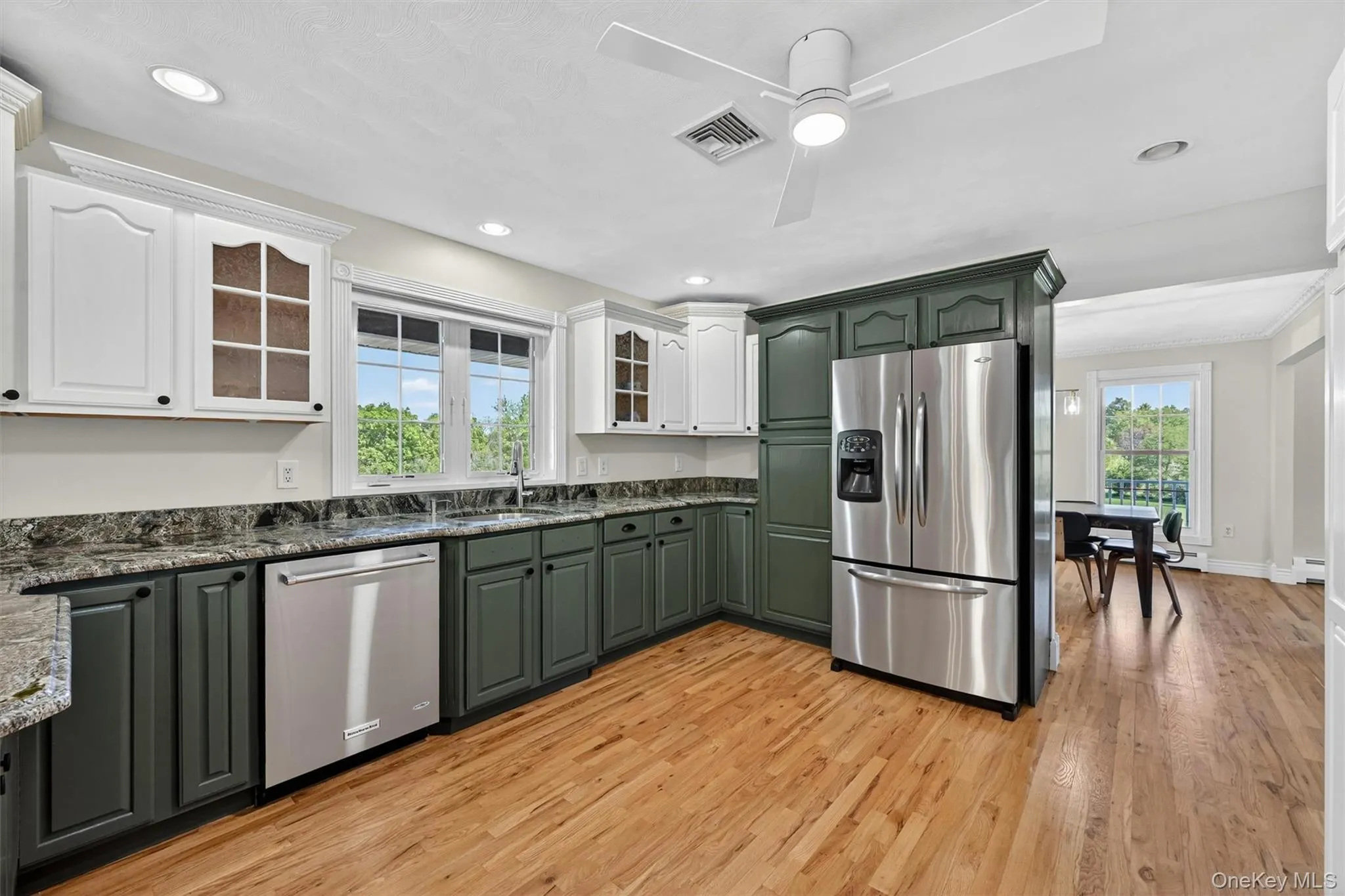 With its freshly painted cabinetry, stainless steel appliances, and hardwood floors, the kitchen feels both polished and comfortable for daily use. With its freshly painted cabinetry, stainless steel appliances, and hardwood floors, the kitchen feels both polished and comfortable for daily use.