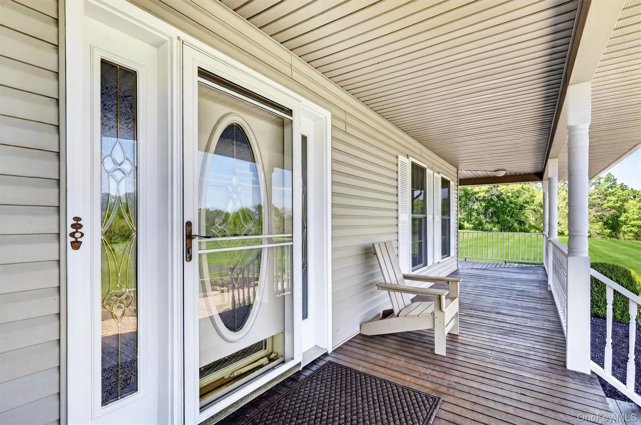 A closer look at the front entry shows the home’s inviting character, with detailed glass doors, a covered porch, and a comfortable spot to sit and unwind. A closer look at the front entry shows the home’s inviting character, with detailed glass doors, a covered porch, and a comfortable spot to sit and unwind.