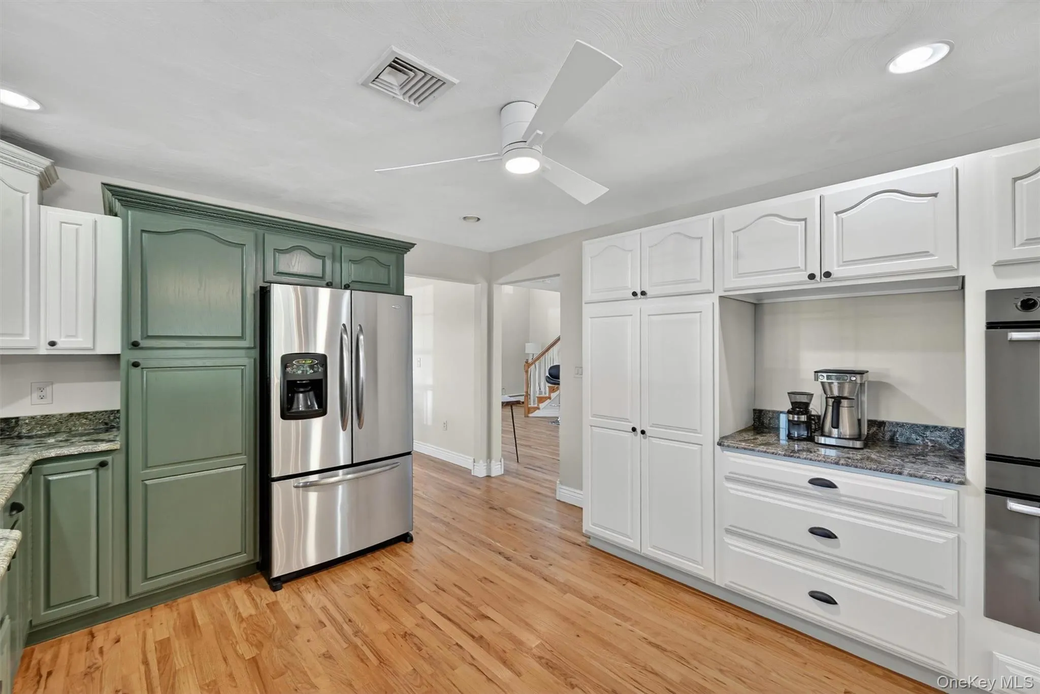 A thoughtful kitchen layout offers built-in storage, stainless steel appliances, and a natural connection to the main living areas. Just beyond the doorway to the right of the refrigerator is the formal dining room, perfectly situated for hosting holidays and guests throughout the year. A thoughtful kitchen layout offers built-in storage, stainless steel appliances, and a natural connection to the main living areas. Just beyond the doorway to the right of the refrigerator is the formal dining room, perfectly situated for hosting holidays and guests throughout the year.